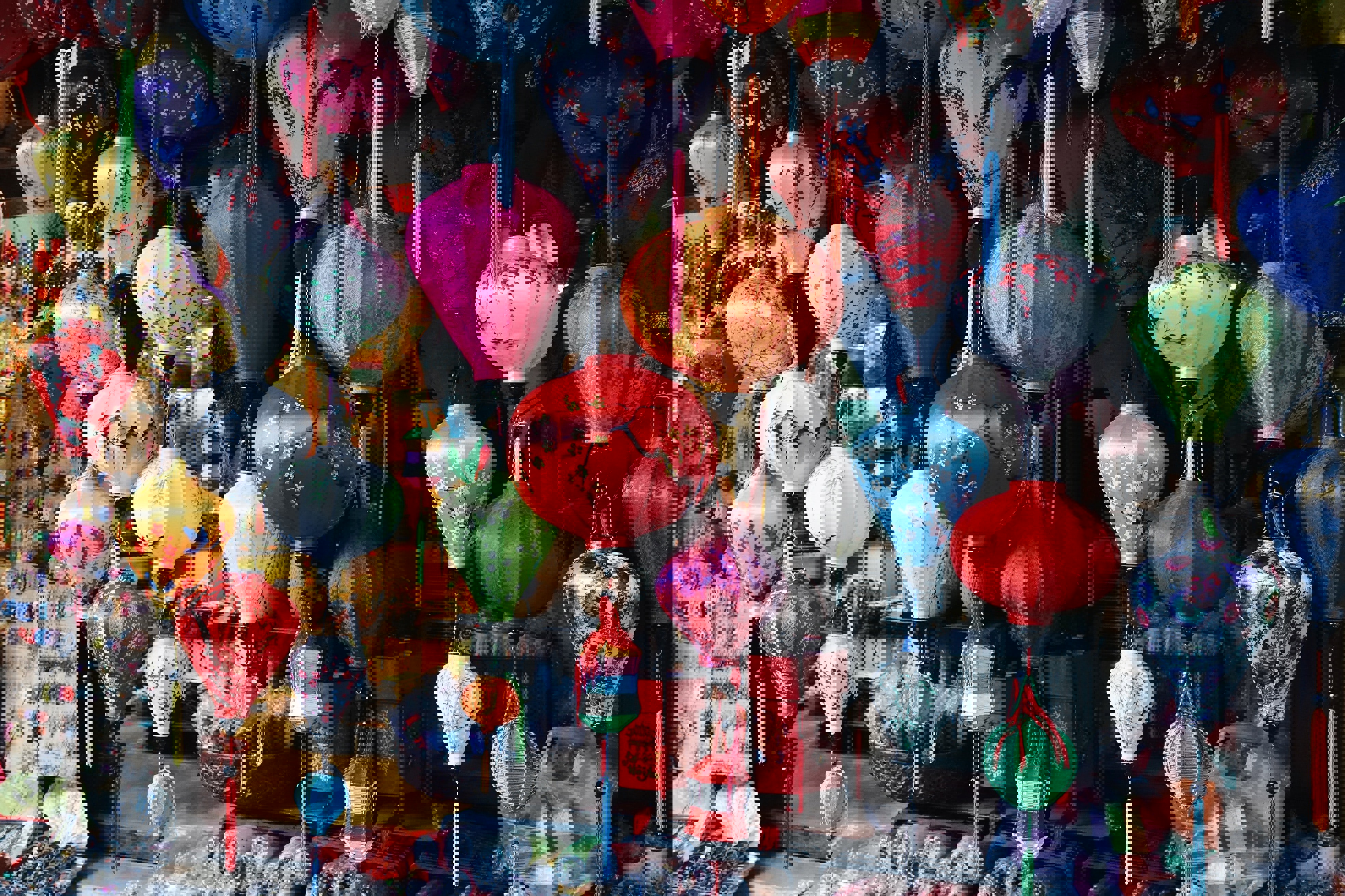Colourful lanterns hung in a market stall in Hoi An Vietnam