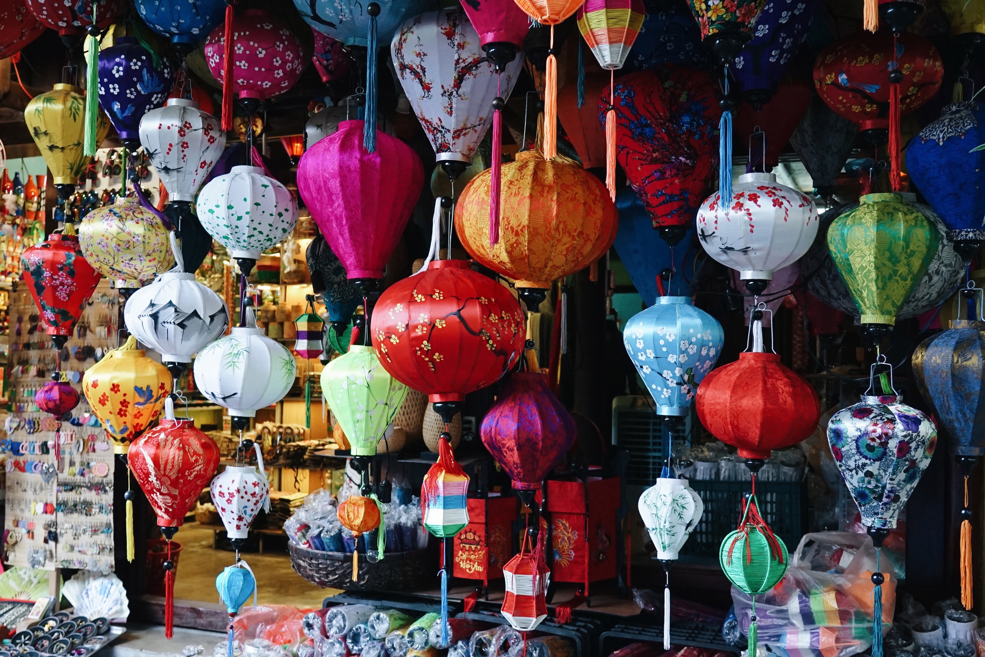 Colourful lanterns hung in a market stall in Hoi An Vietnam