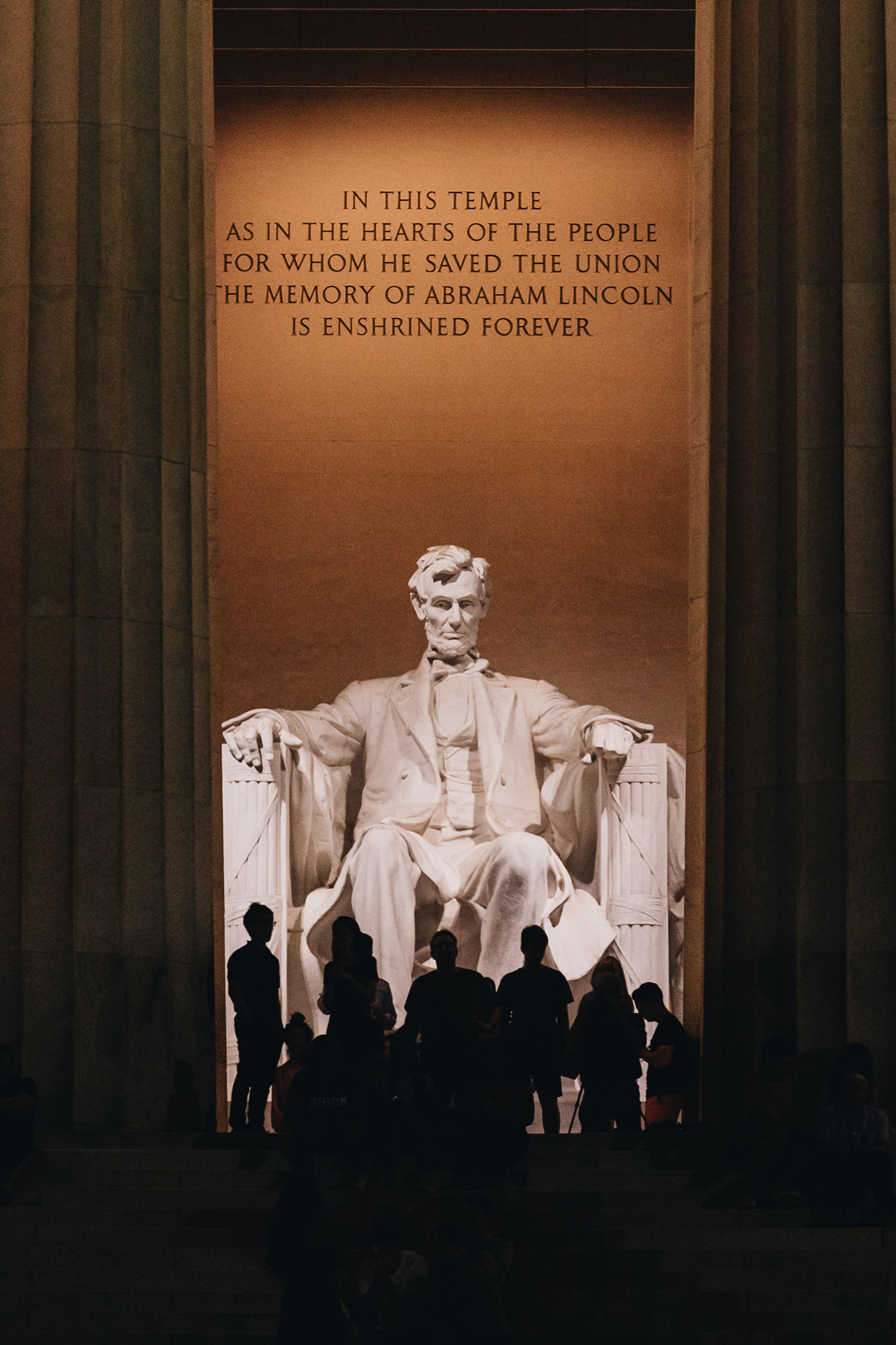 Night time silhouettes of people at the Lincoln Memorial in Washington, DC