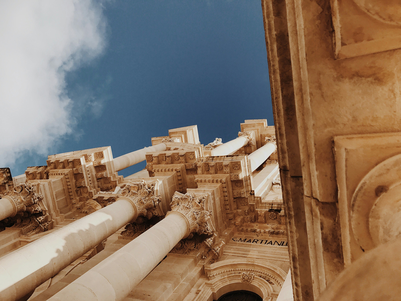 Europe, Italy, Sicily, Ortigia, building facade looking upwards to blue sky