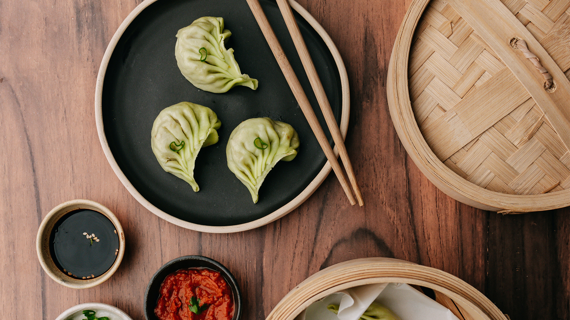 Green Dumplings on Black Plate