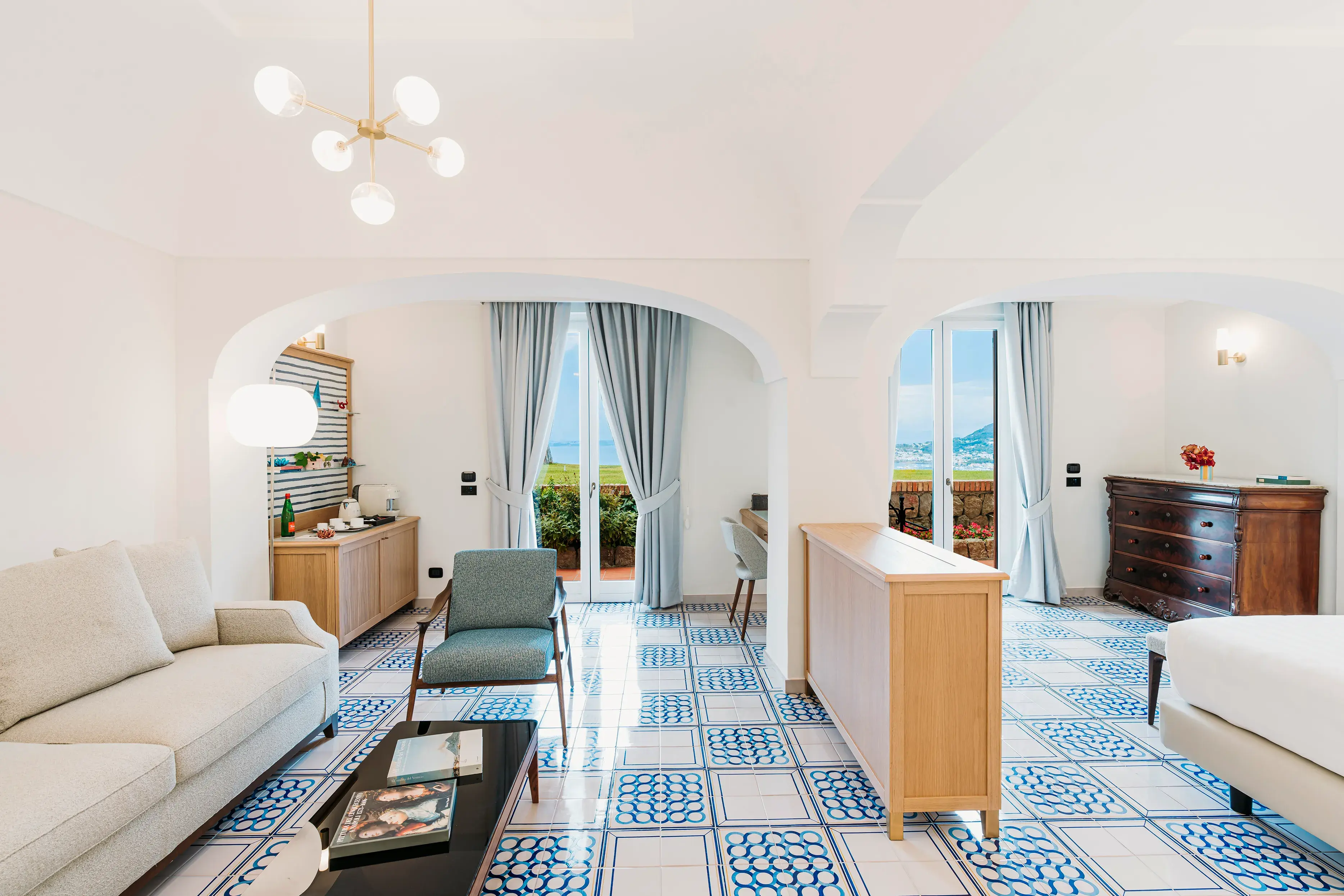 Luxurious suite at San Montano Resort on Ischia with elegant furnishings, sea view, and stylish decor.