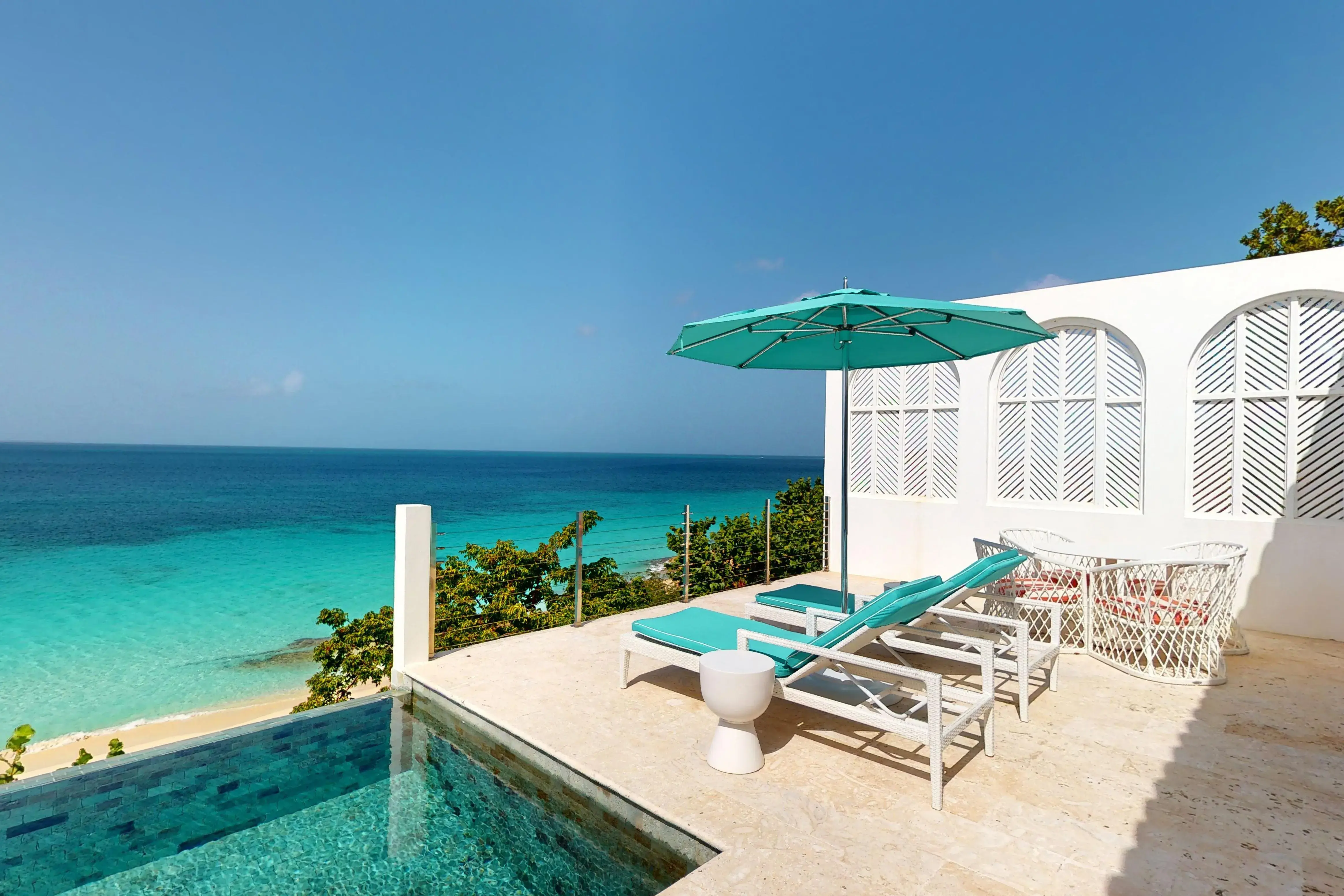 Luxury terrace at Malliouhana Resort, Anguilla, featuring a private plunge pool, oceanfront loungers, and panoramic Caribbean Sea views