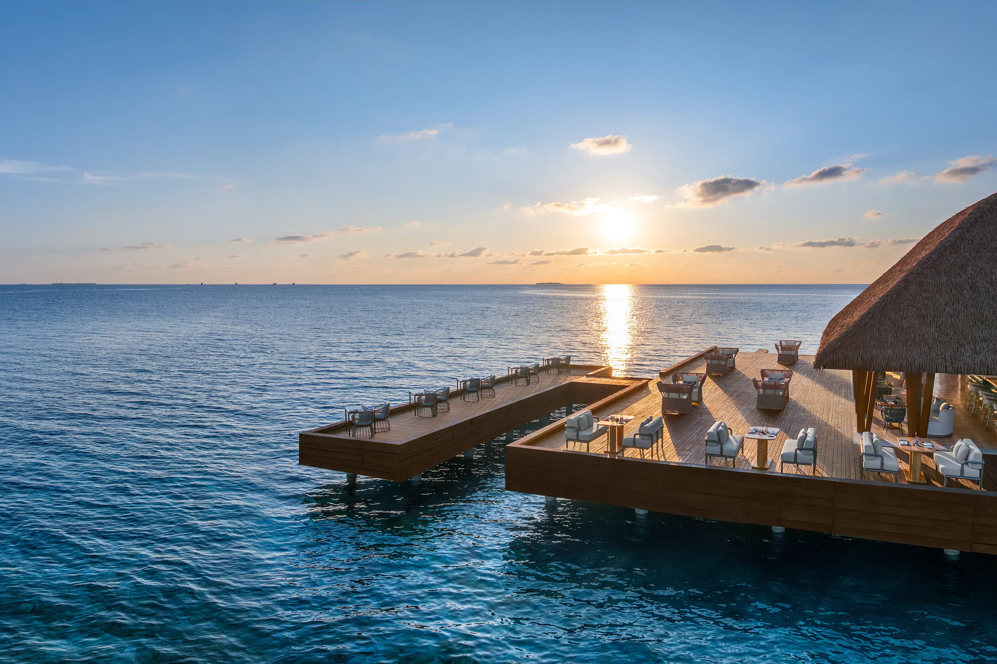 FISH restaurant at W Maldives featuring stylish overwater dining decks, panoramic Indian Ocean views, and spectacular sunset scenery above the turquoise waters of the Maldives
