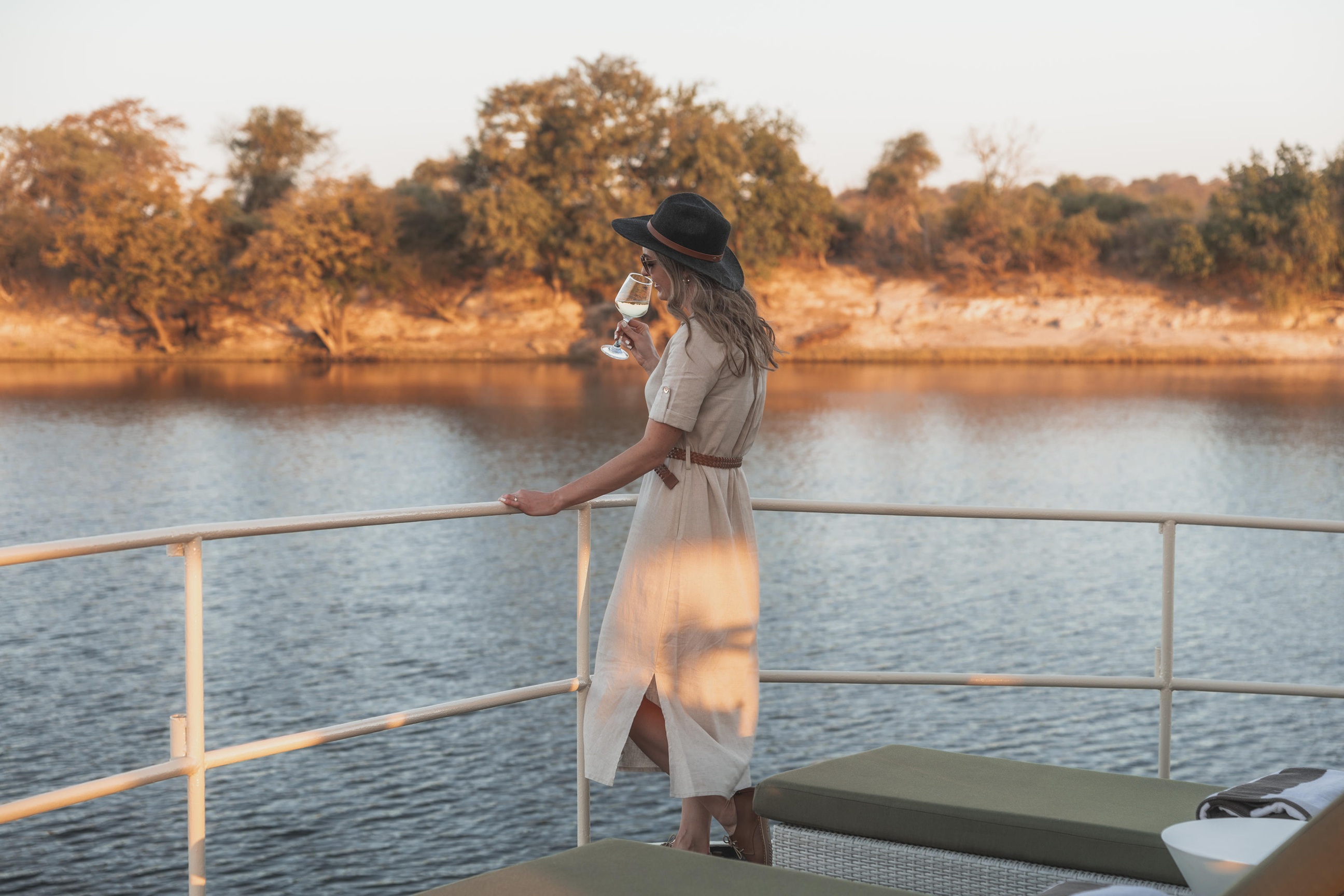 Sunset drinks on deck aboard the Chobe Princess river houseboat