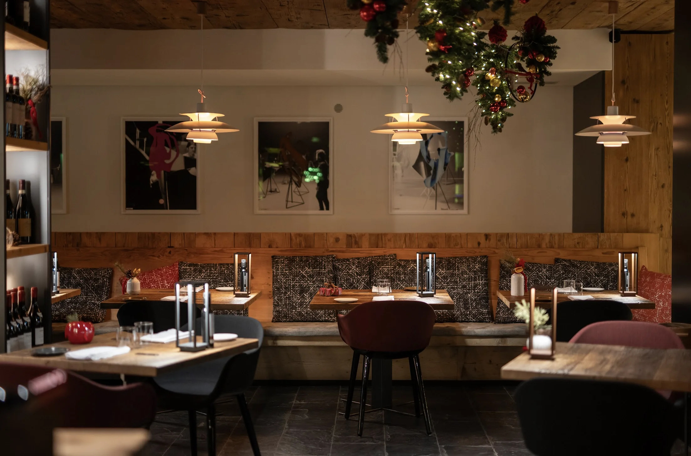 Alpine-chic tables set up for dinner with cosy lighting and ski-themed wall art