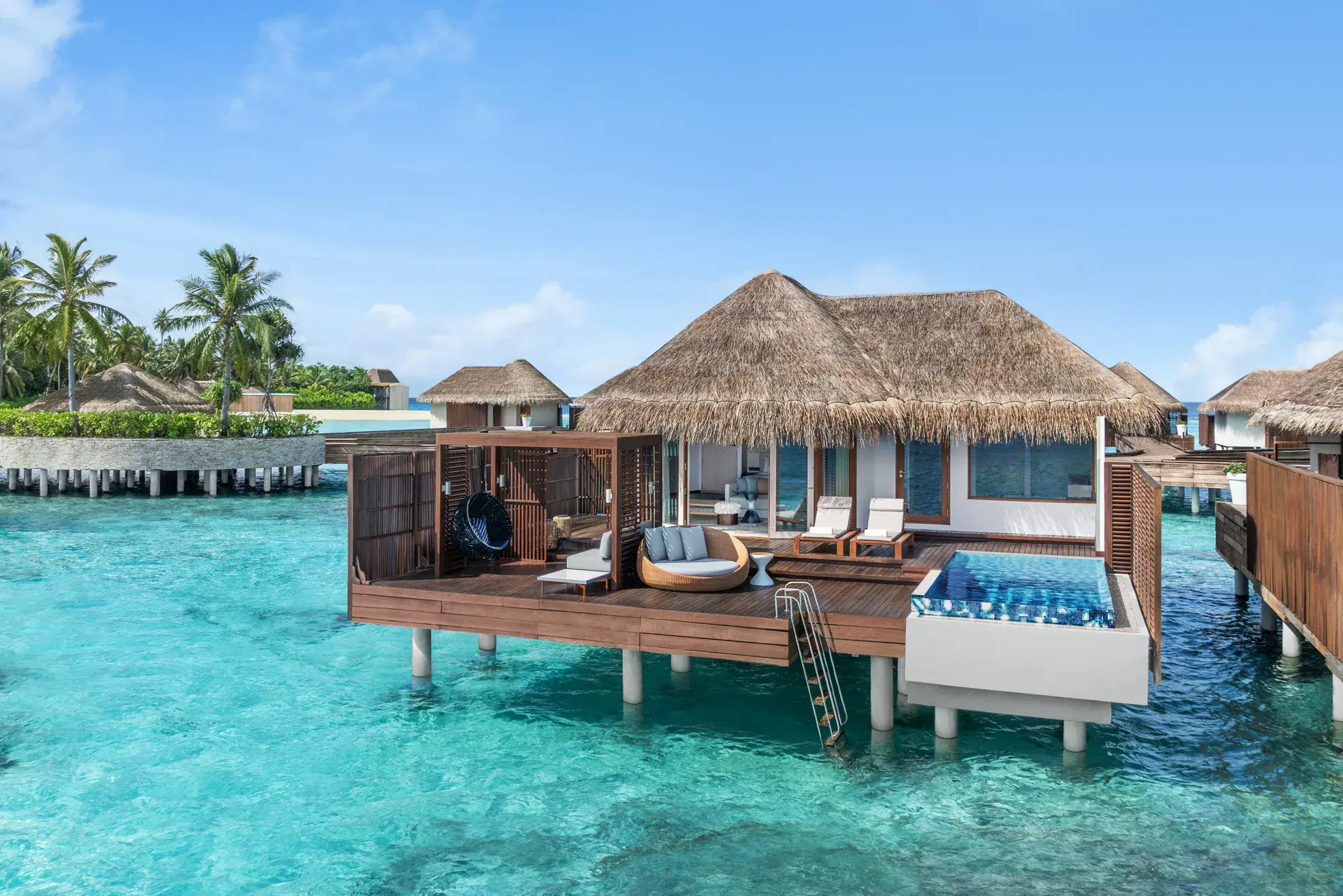 W Maldives Premier Overwater One-Bedroom Villa with private infinity pool, spacious sun deck, and direct lagoon access above the crystal-clear turquoise waters of the Maldives