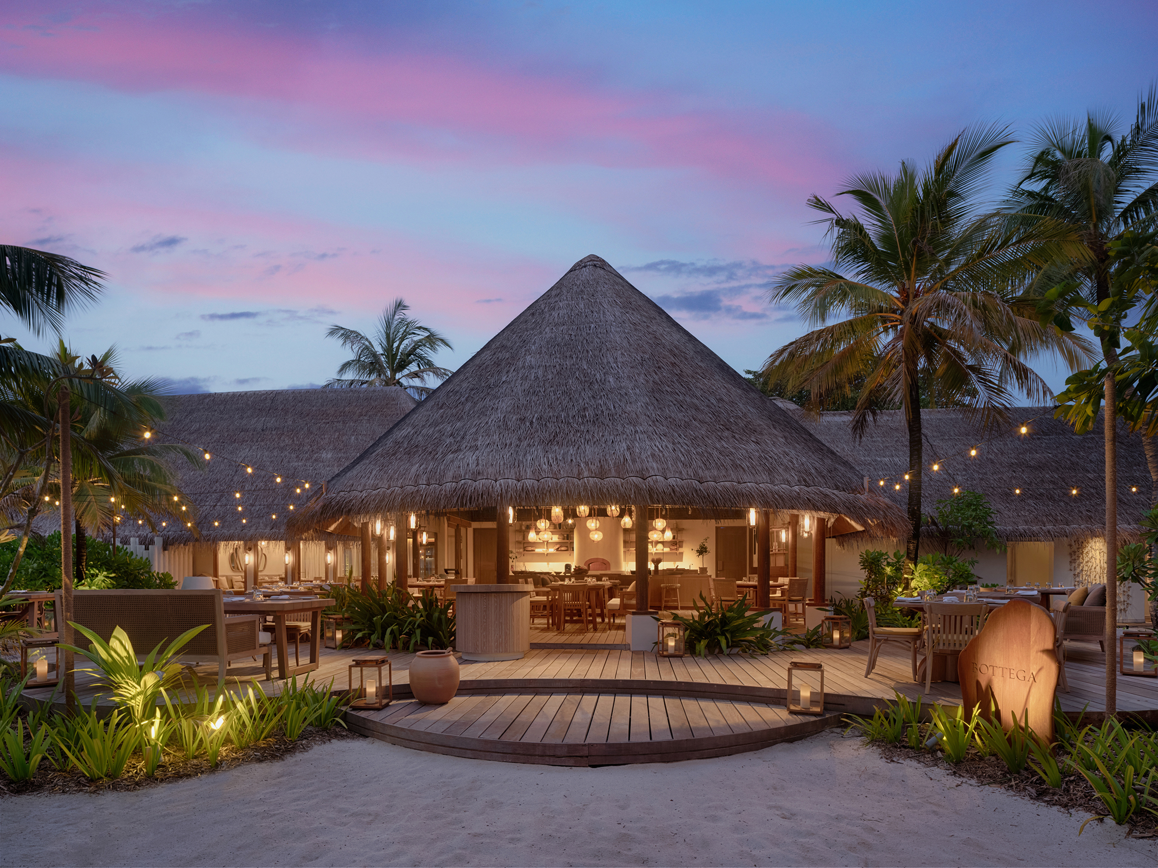 Exterior with conical thatched roof of Bottega restaurant at Six Senses Kanuhura 