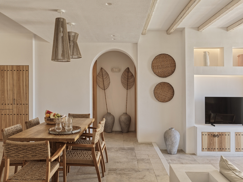 Villa dining area with table and rattan decor at Lesante Cape