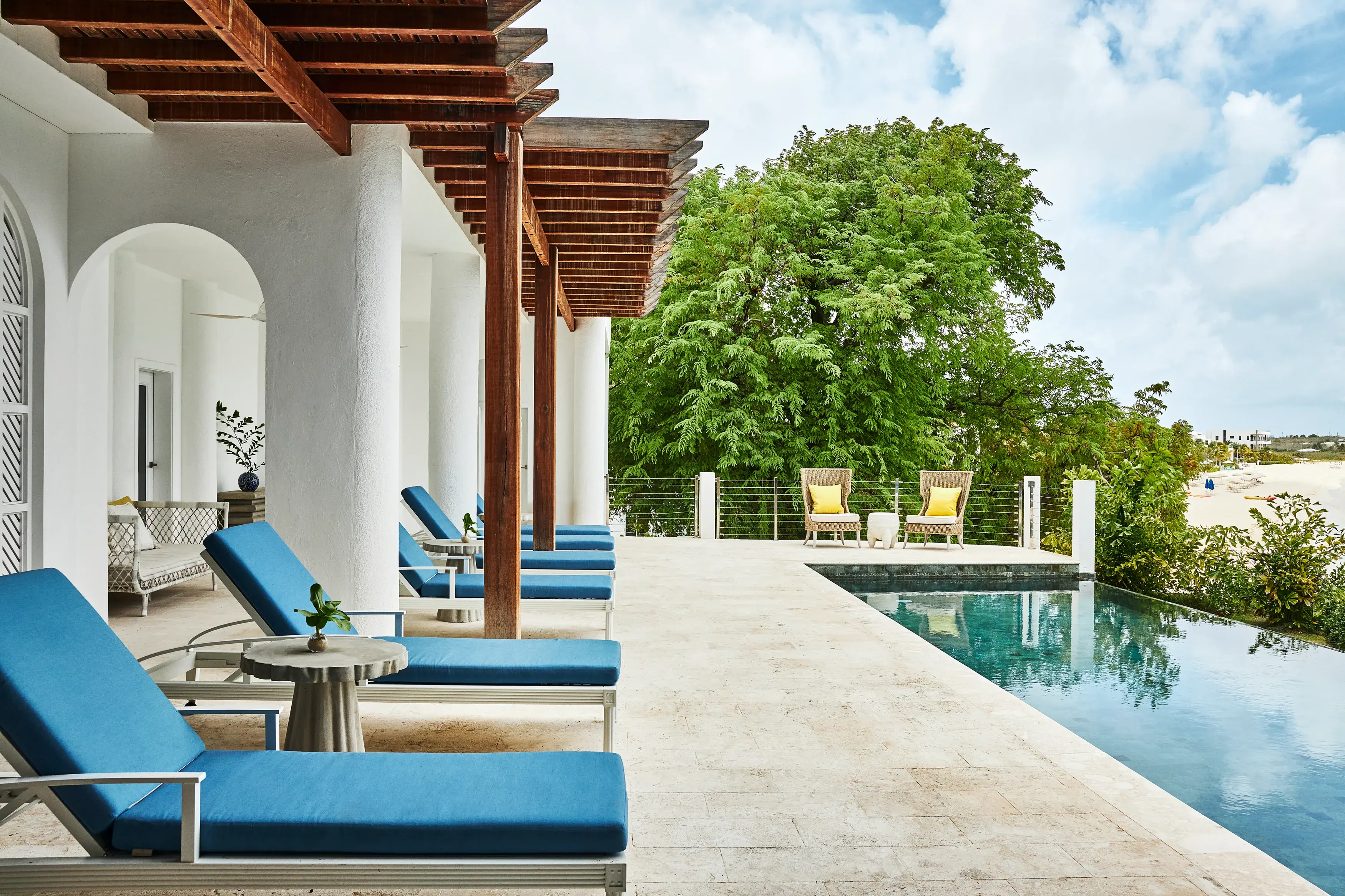 Malliouhana Spa relaxation lounge in Anguilla featuring a private pool, luxury sun loungers, and serene beachfront views in the Caribbean