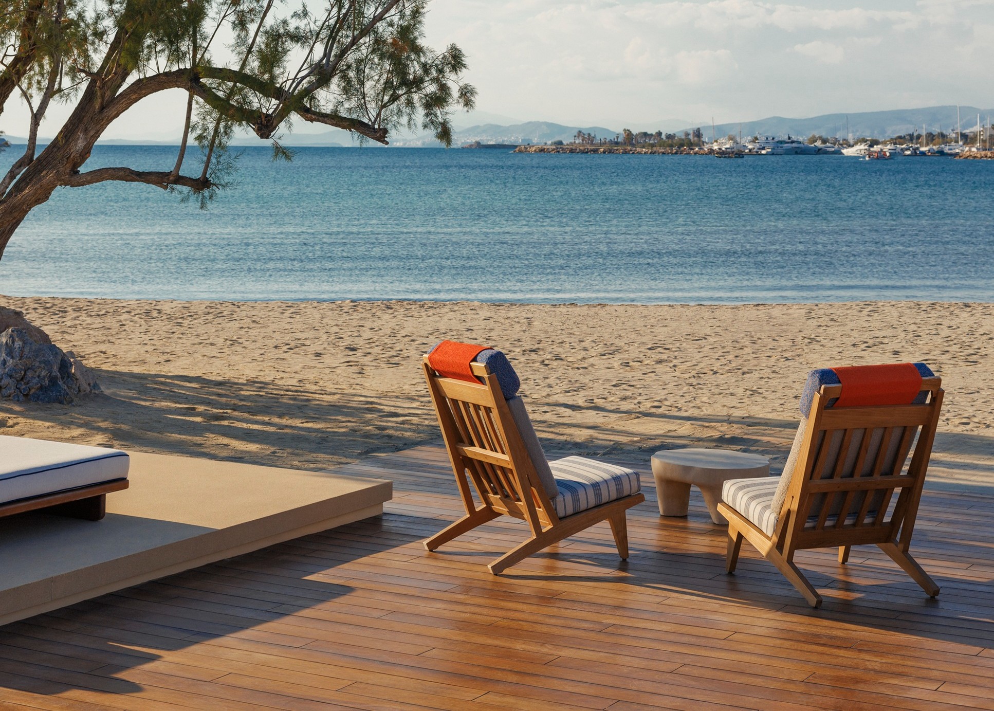 Beachfront loungers overlooking a tranquil bay at a luxury Greek island resort