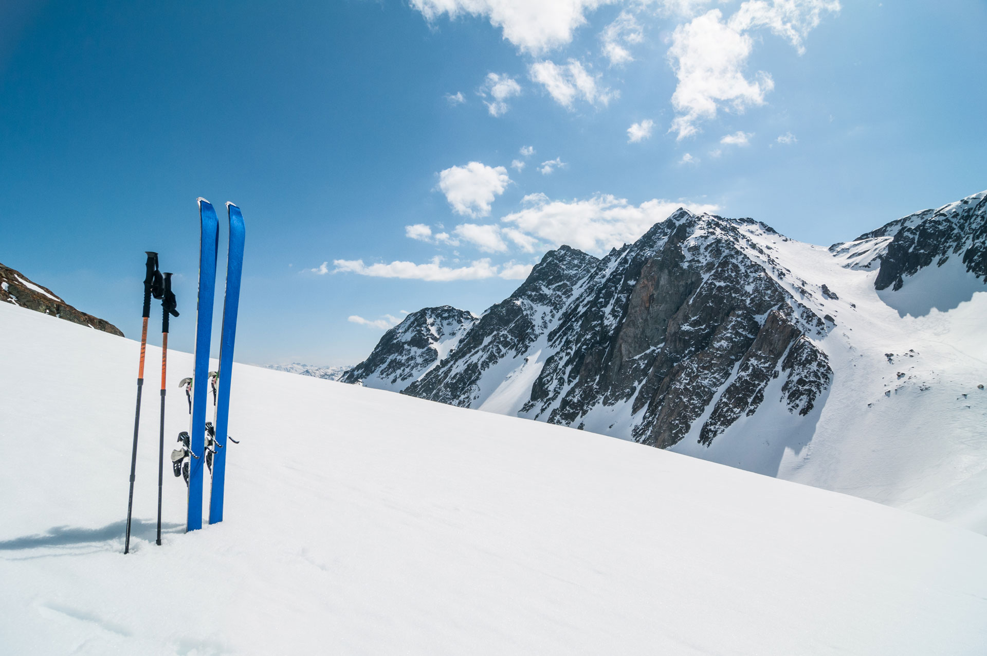 A pair of skis and sticks stuck out of the snow