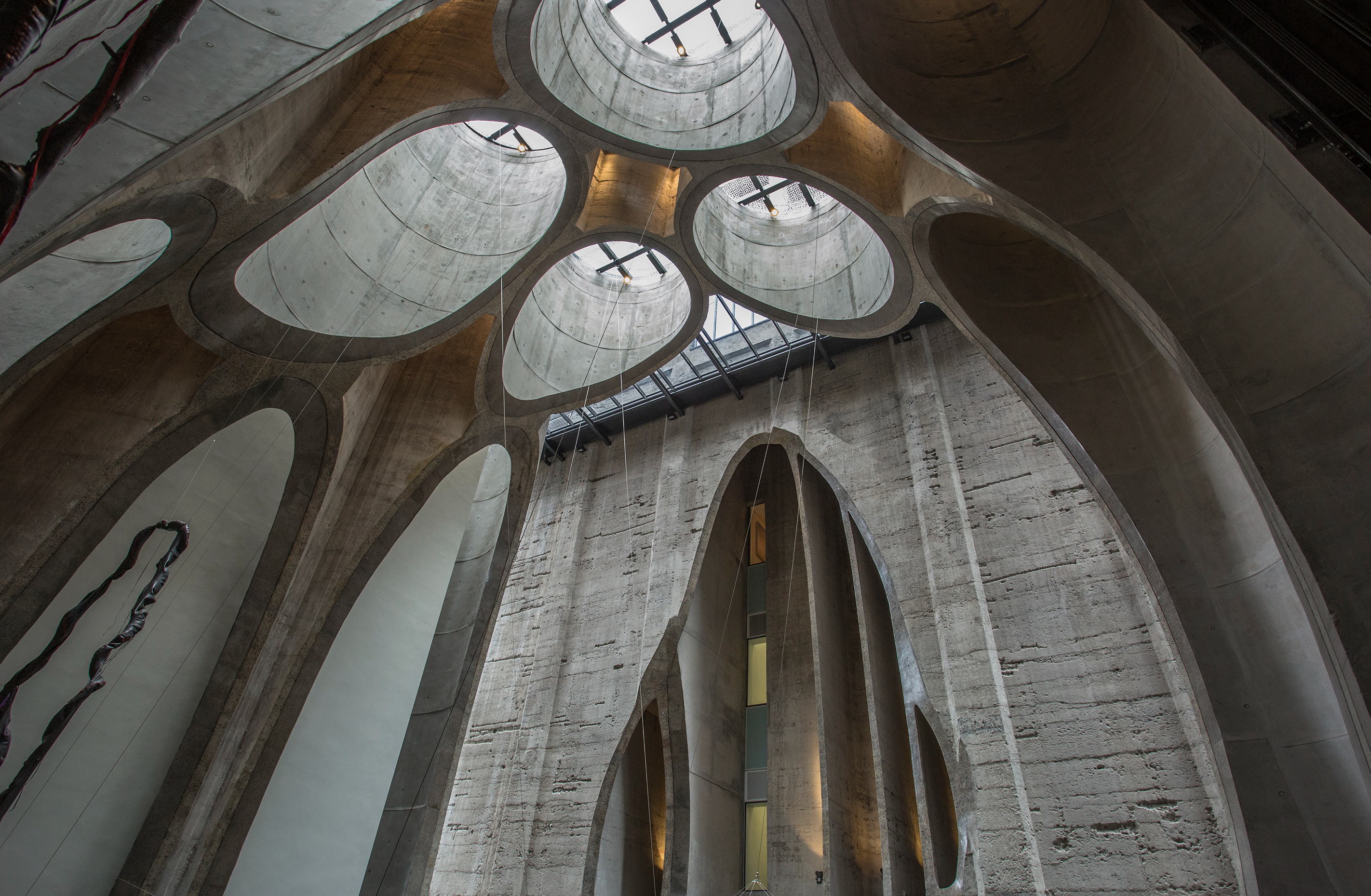 Architectural interior of Zeitz MOCAA museum in Cape Town featuring sculpted concrete atrium with circular skylights.