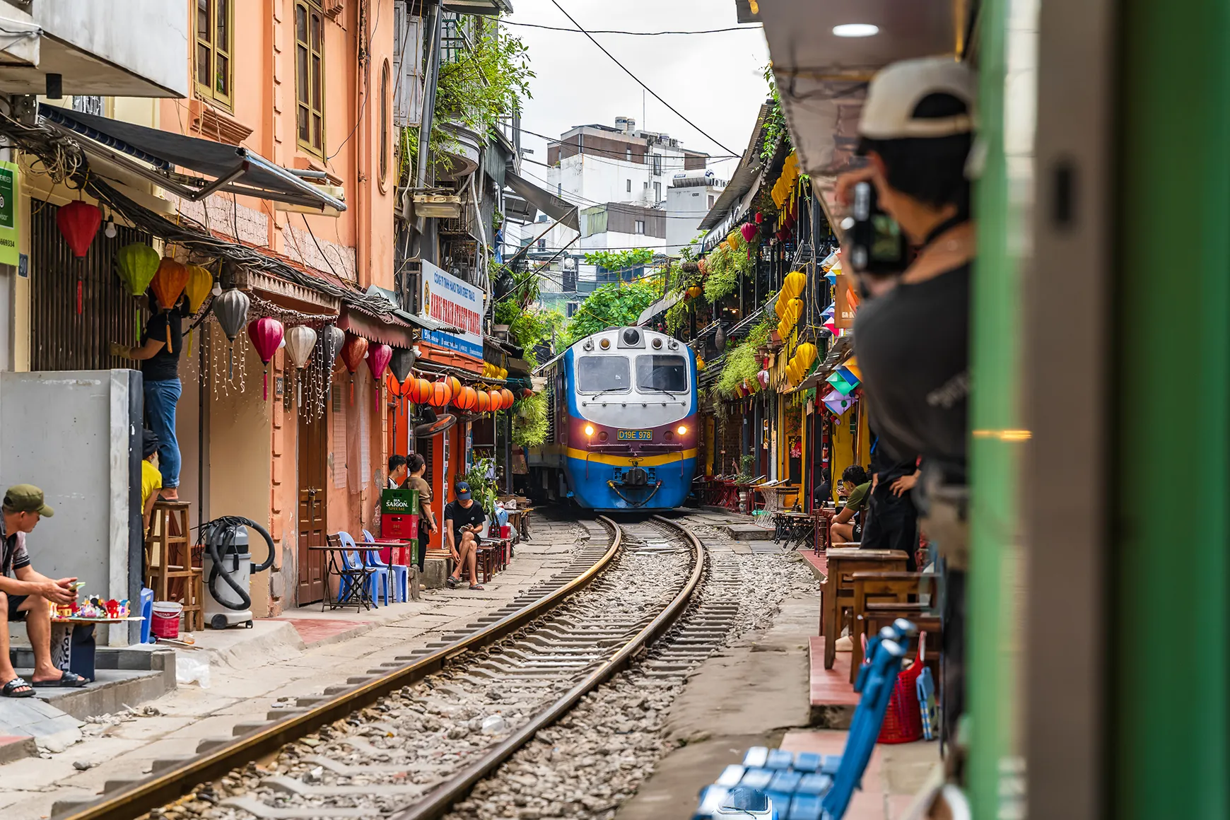 A train passes through a narrow street in Hanoi's Old Quarter