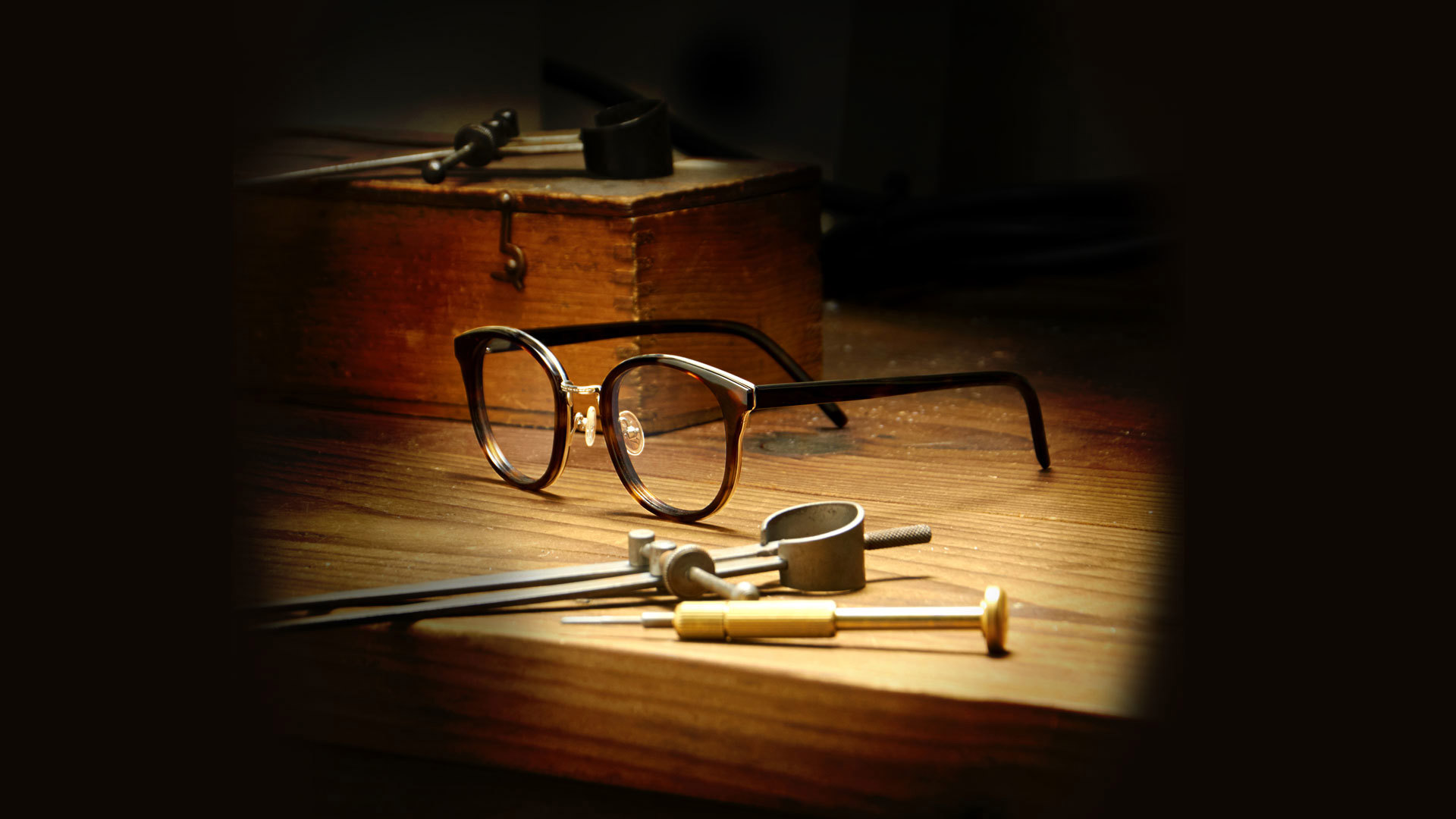 Glasses framed on a wooden desk
