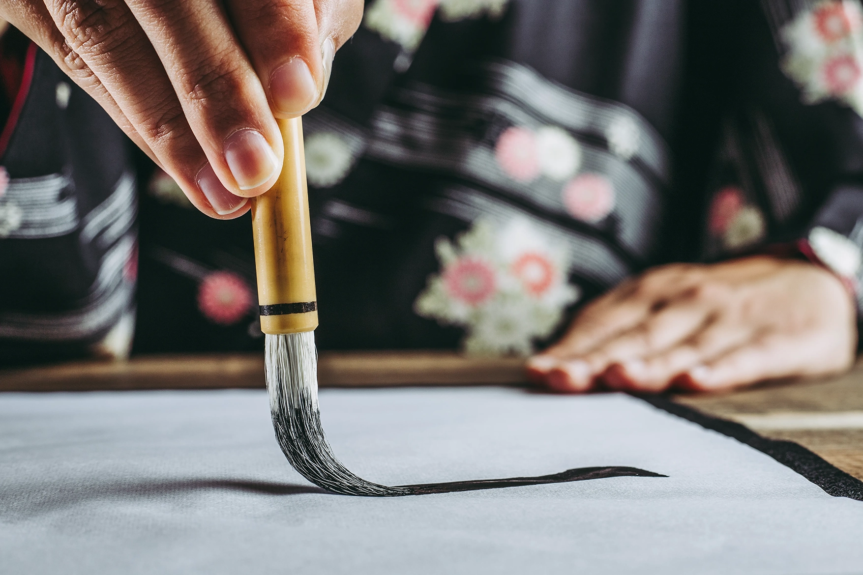 Woman painting Japanese calligraphy