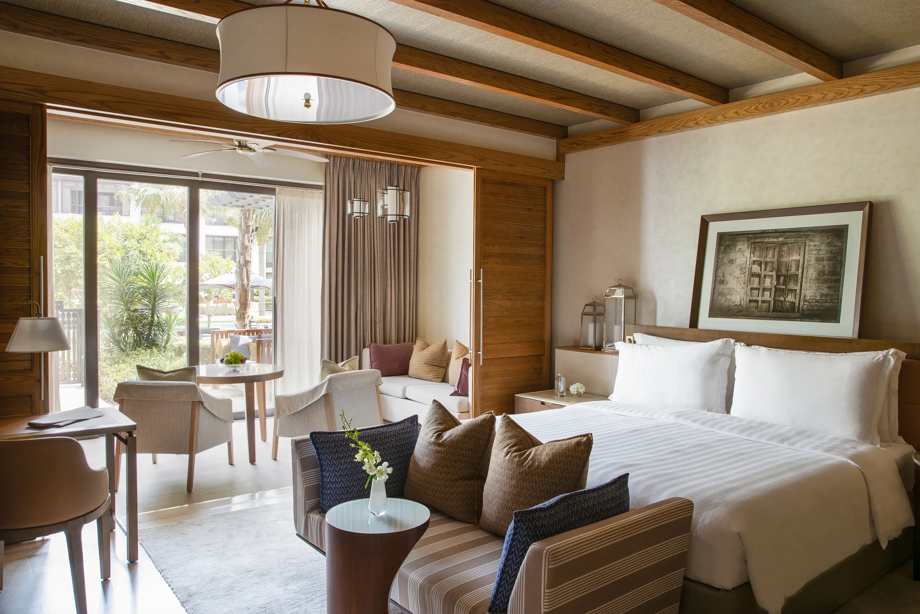 Elegant Pool Terrace Room at Jumeirah Al Naseem Dubai featuring contemporary décor, a spacious seating area and direct access to a private outdoor terrace.