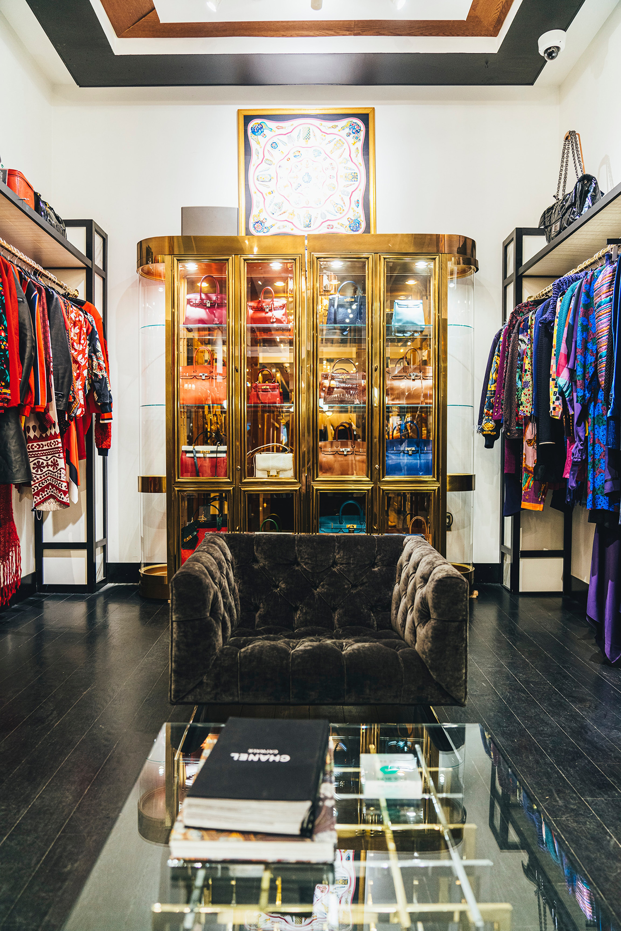 A room of luxury clothes on hangers and in a golden bag storage