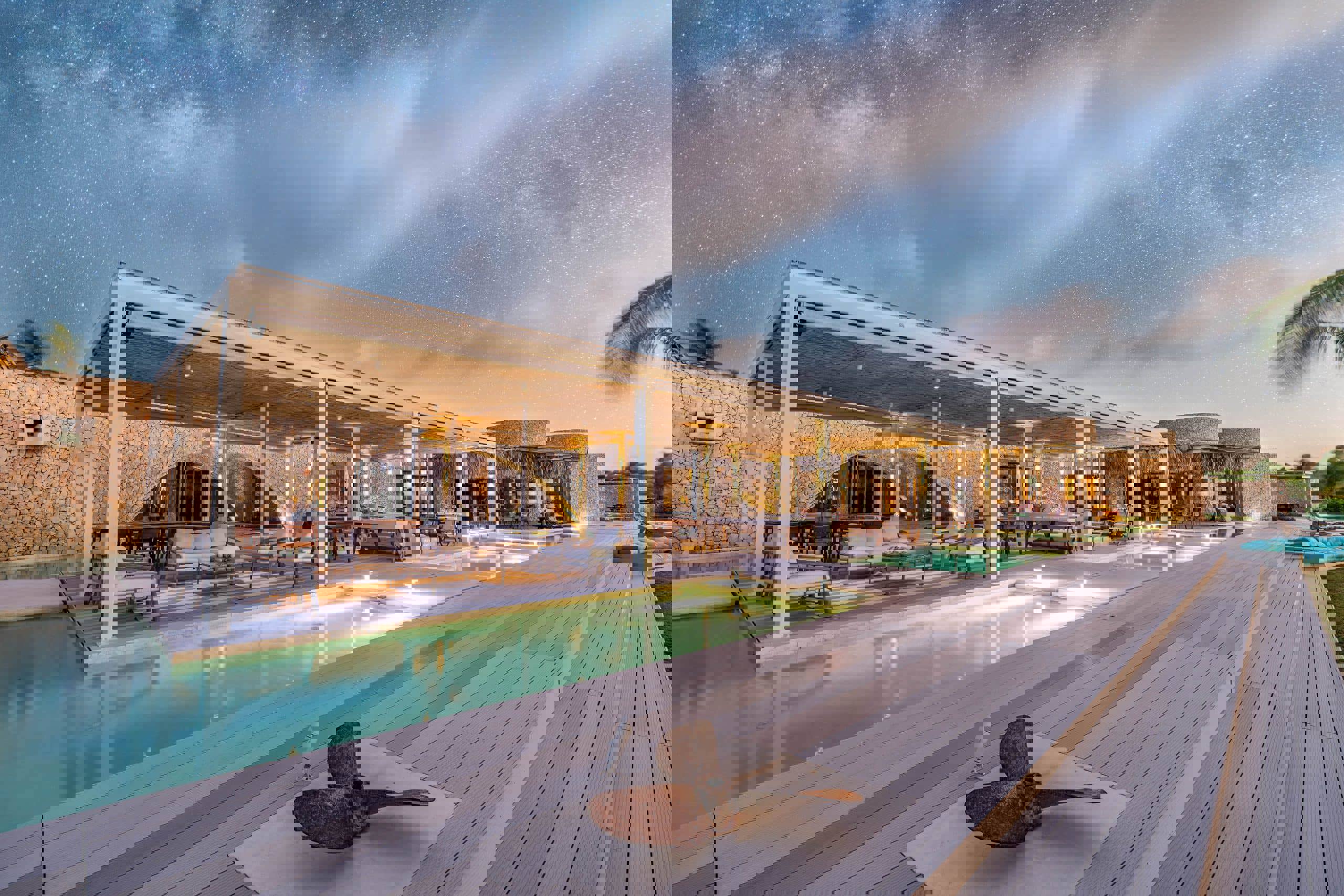 Miavana piazza restaurant and water lit up for sunset