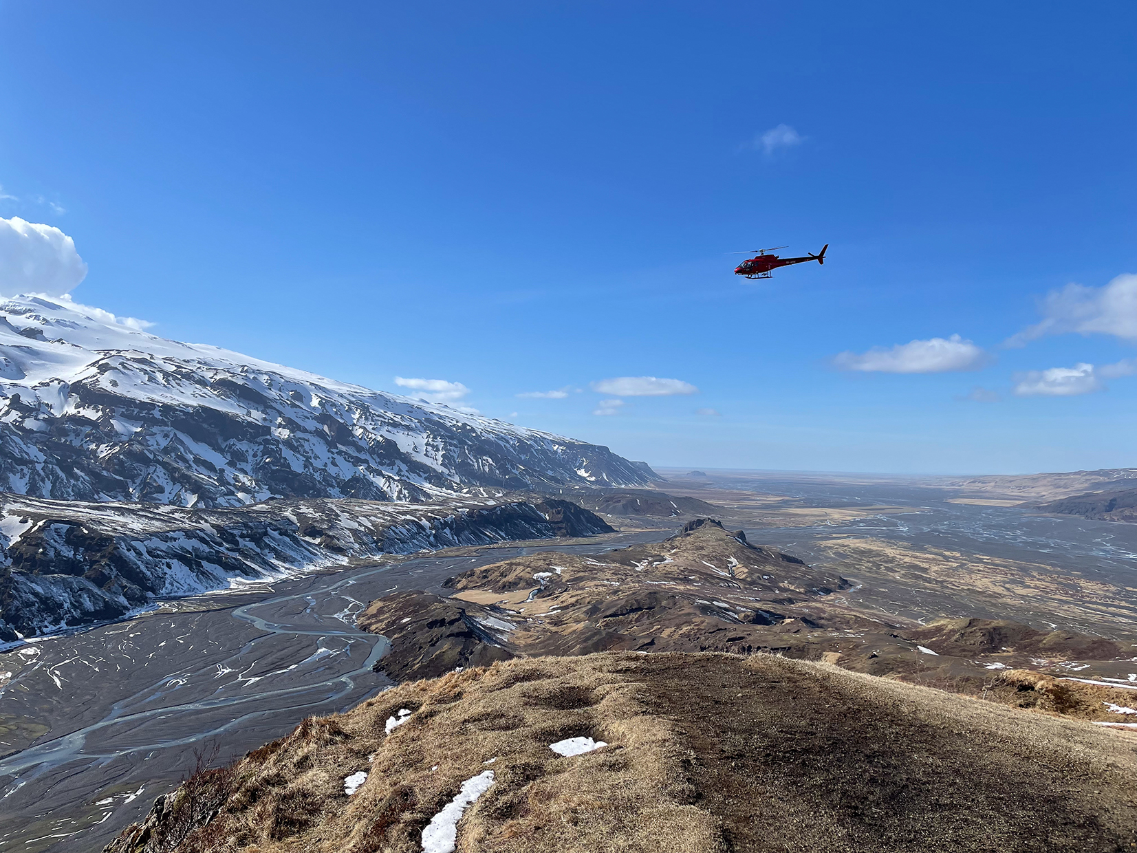 Europe, Iceland, Helicopter flying over a mountain