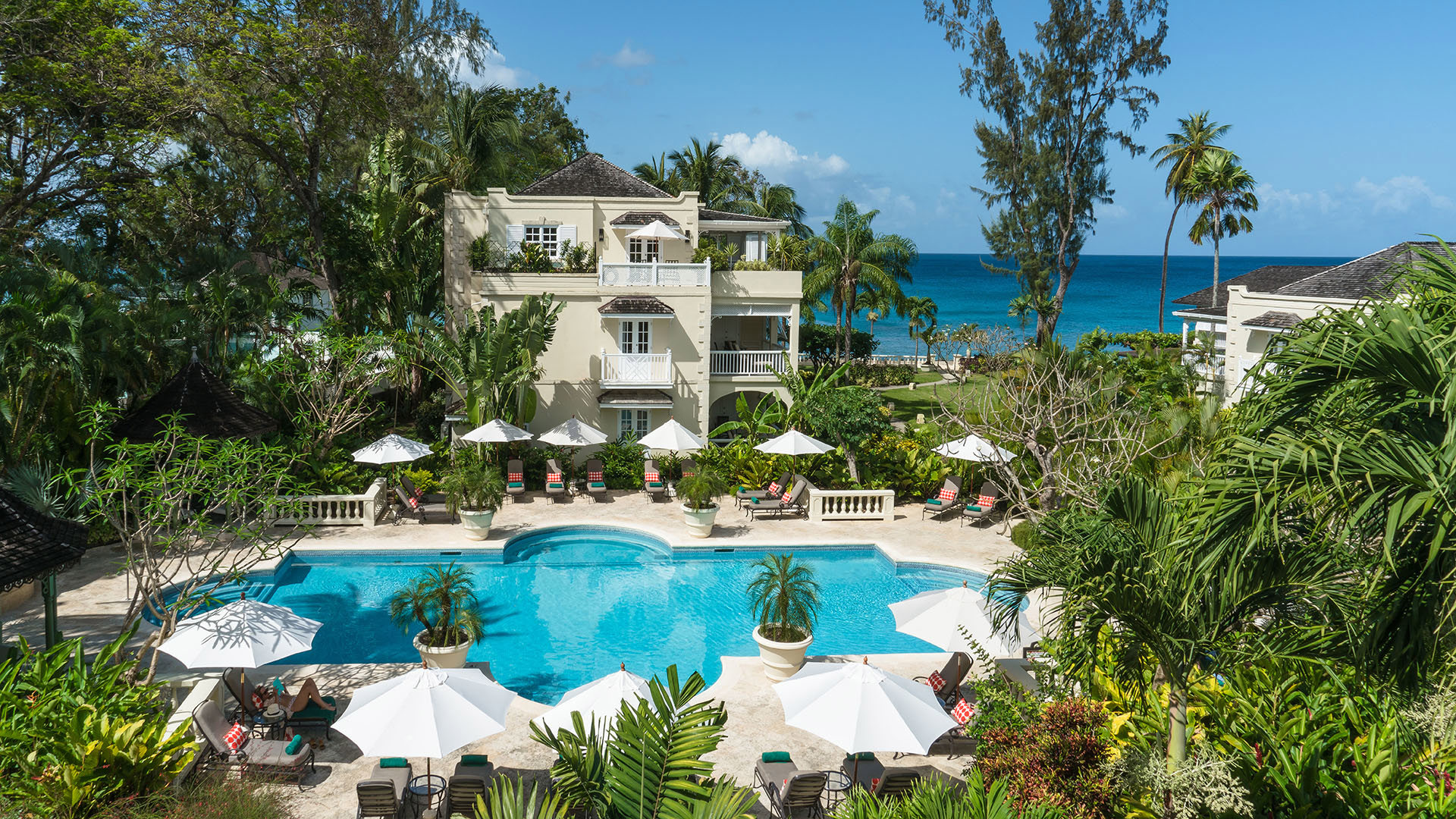 The main pool surrounded by greenery at Coral Reef Club in Barbados