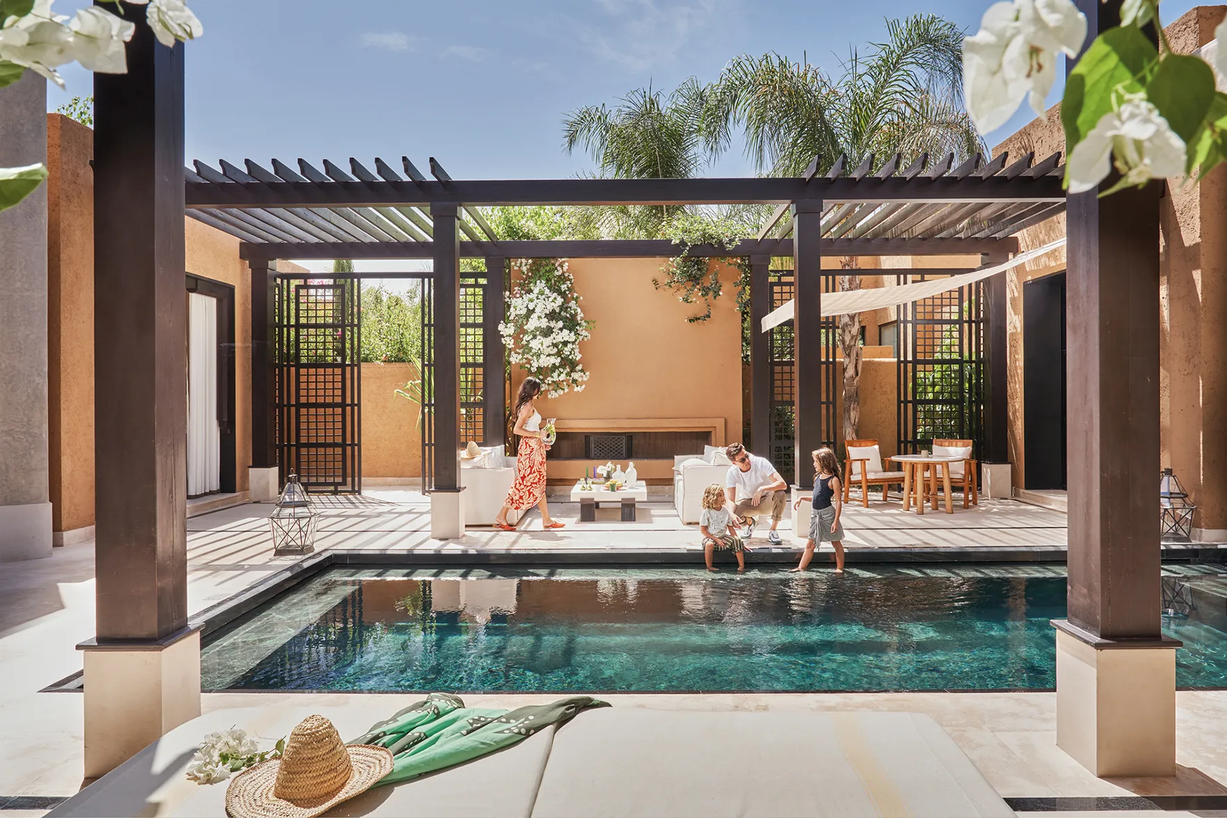 A family around a pool at Mandarin Oriental Marrakech, Morocco