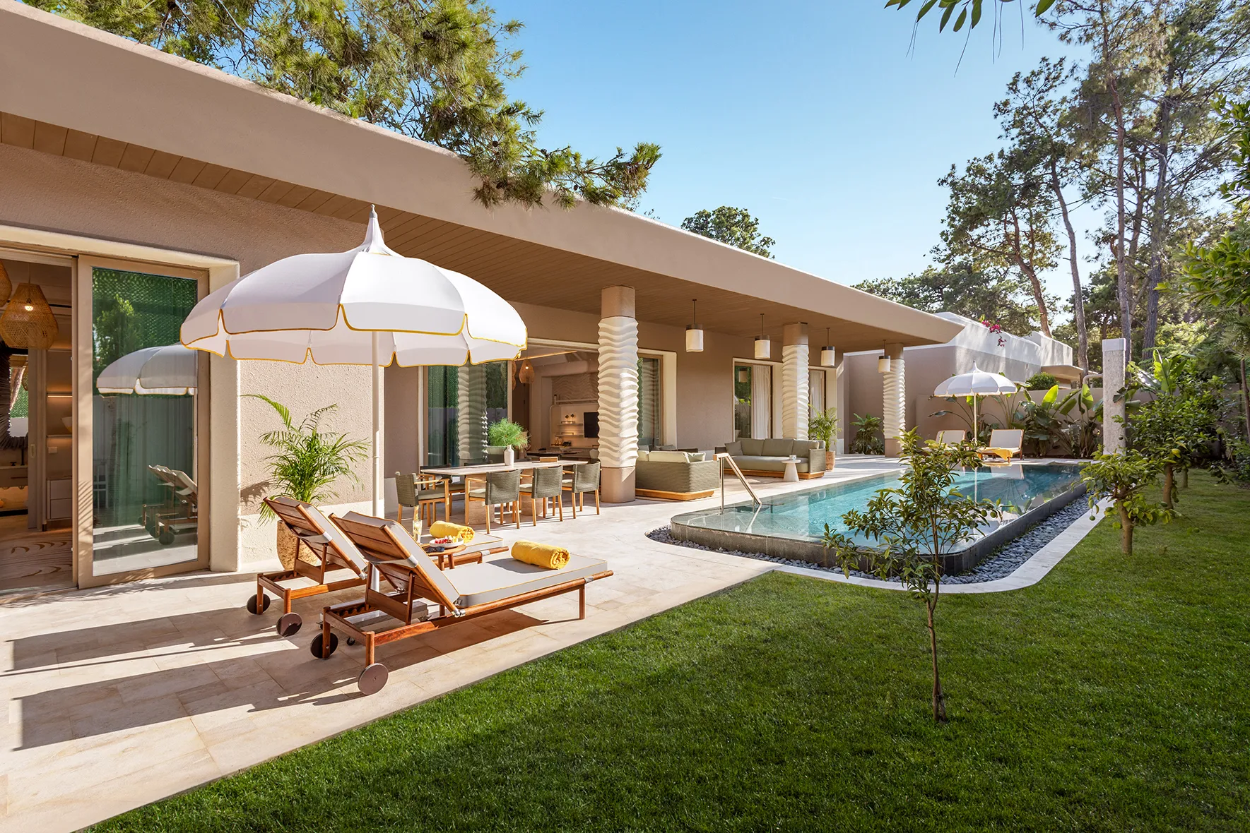 Europe, Turkey, Bijal, private pool outside a Four Bedroom Villa, surrounded by grass, two sunloungers and outdoor lounge and dining areas