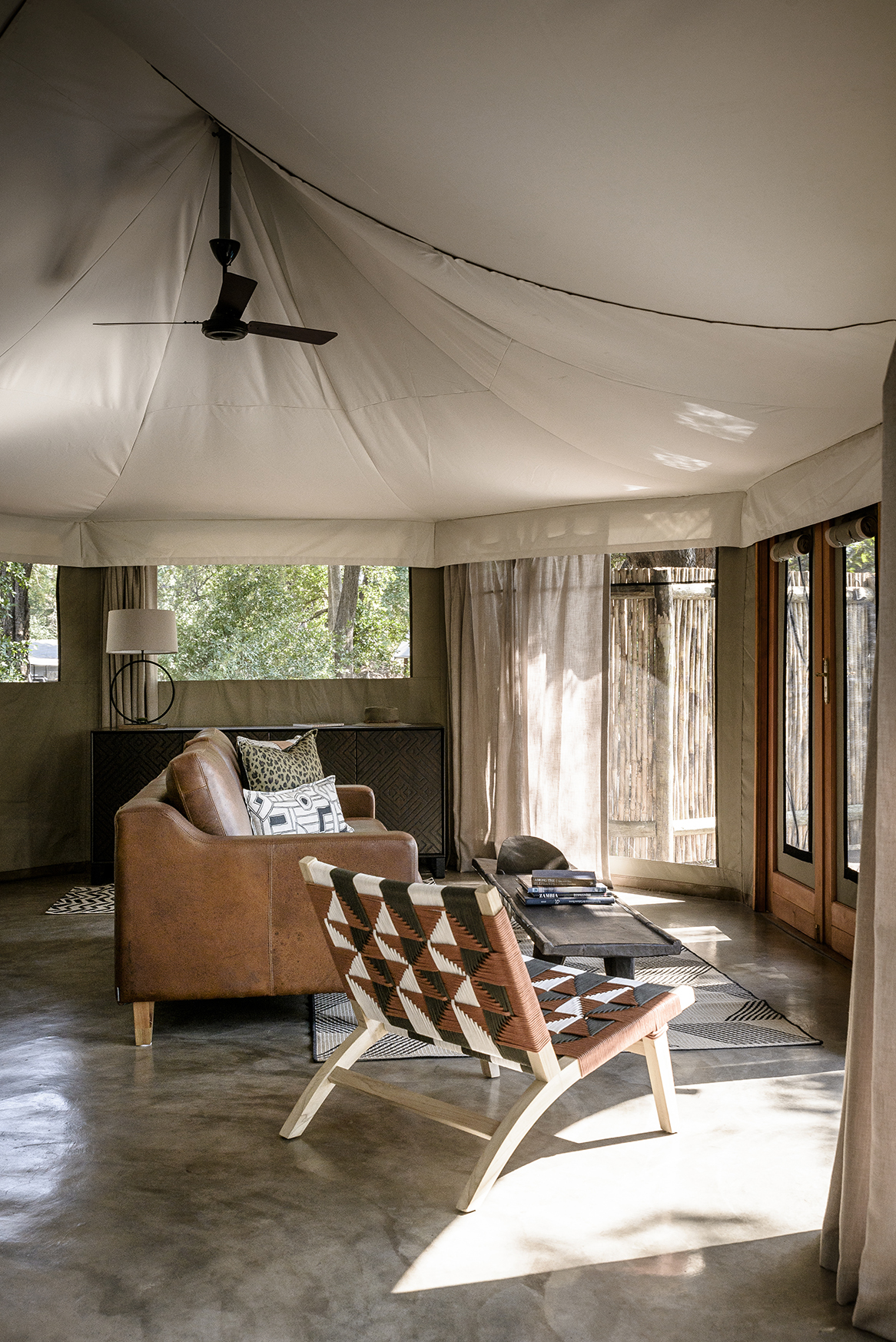 Africa, Zambia, Sungani Lodge, living space in a tented suite made up of a sofa, chair and coffee table