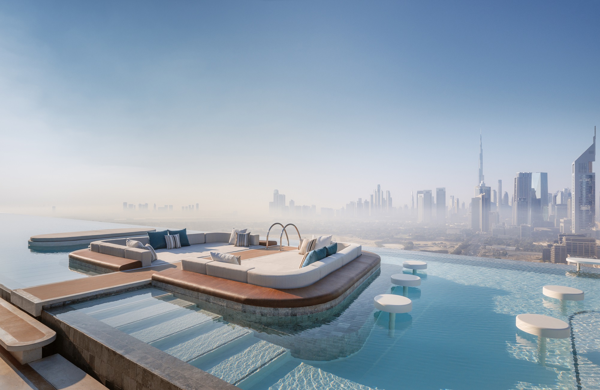 A luxurious rooftop infinity pool with a plush seating area overlooking a Dubai city skyline.