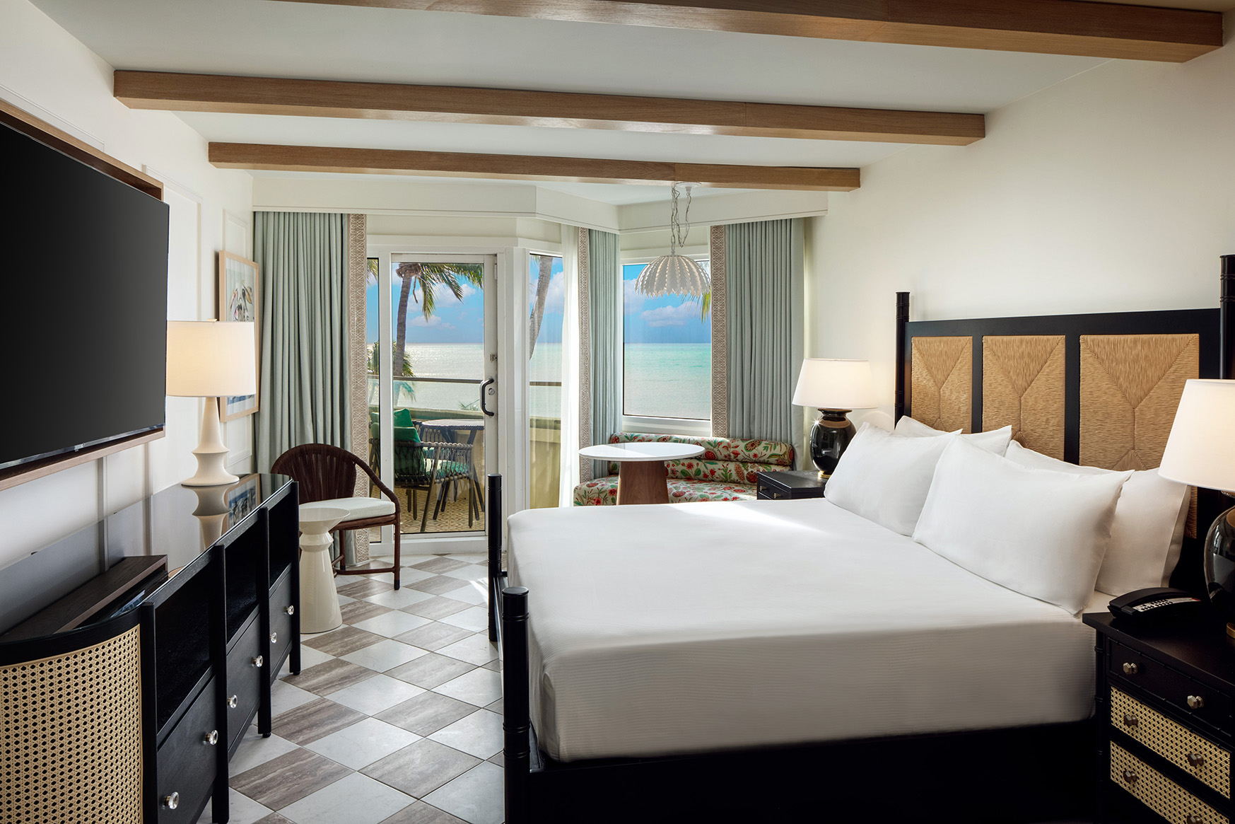 An oceanfront guest room with a king sized bed and balcony at Casa Marinas Key West, Florida 