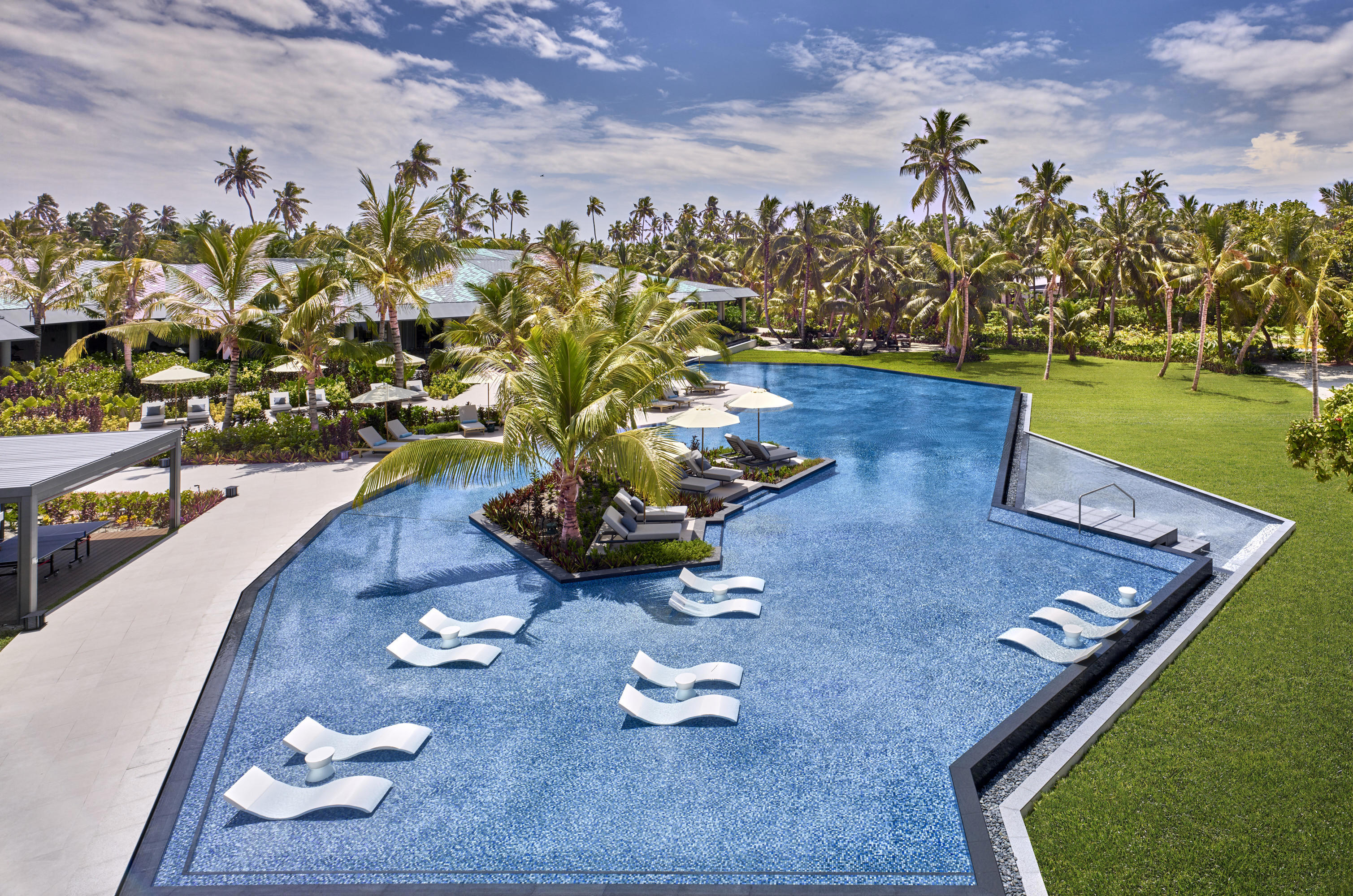 Pool with loungers in at Waldorf Astoria Seychelles