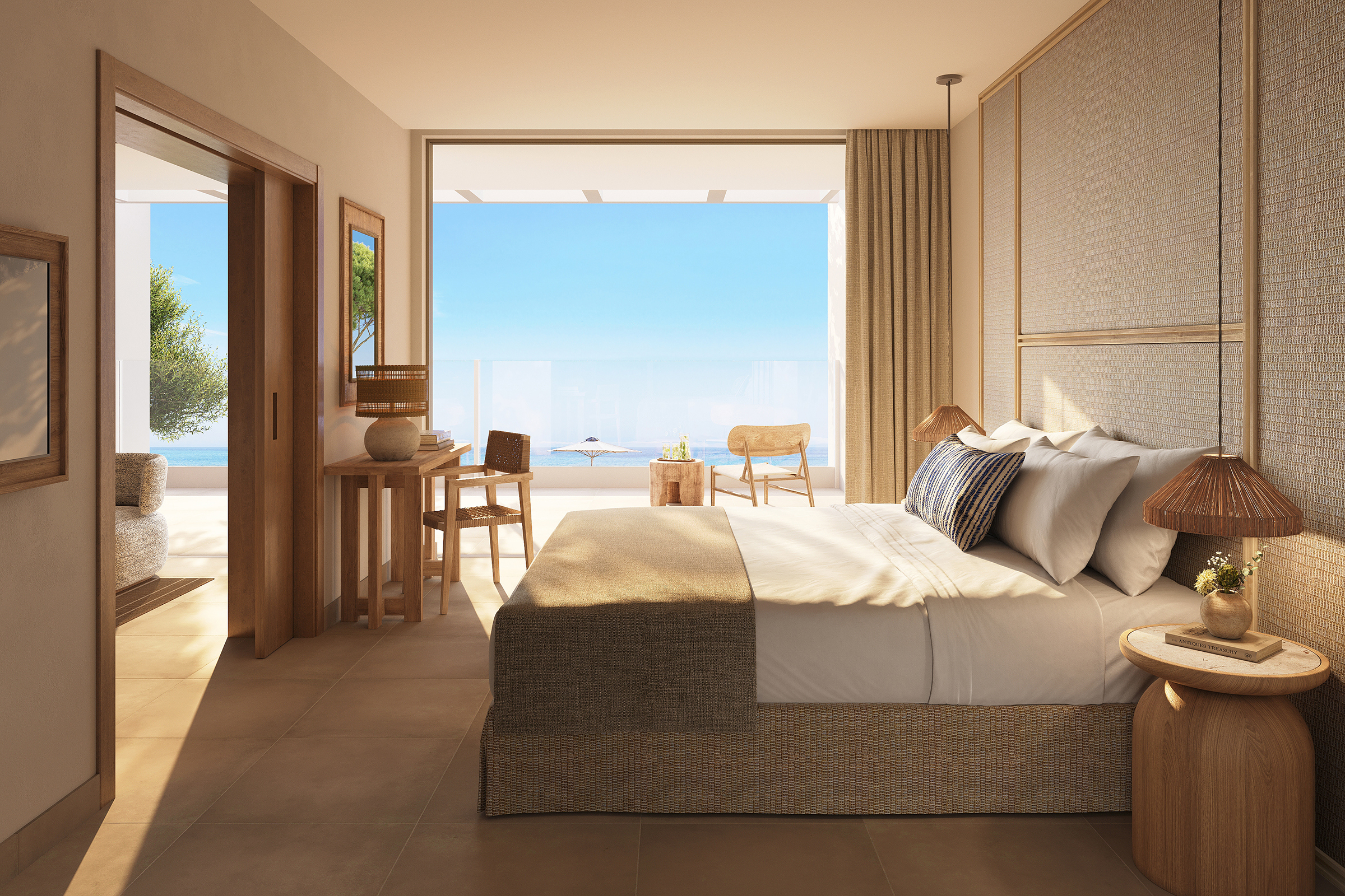 A neutrally toned room with textured walls featuring comfy furniture and large windows leading onto a balcony