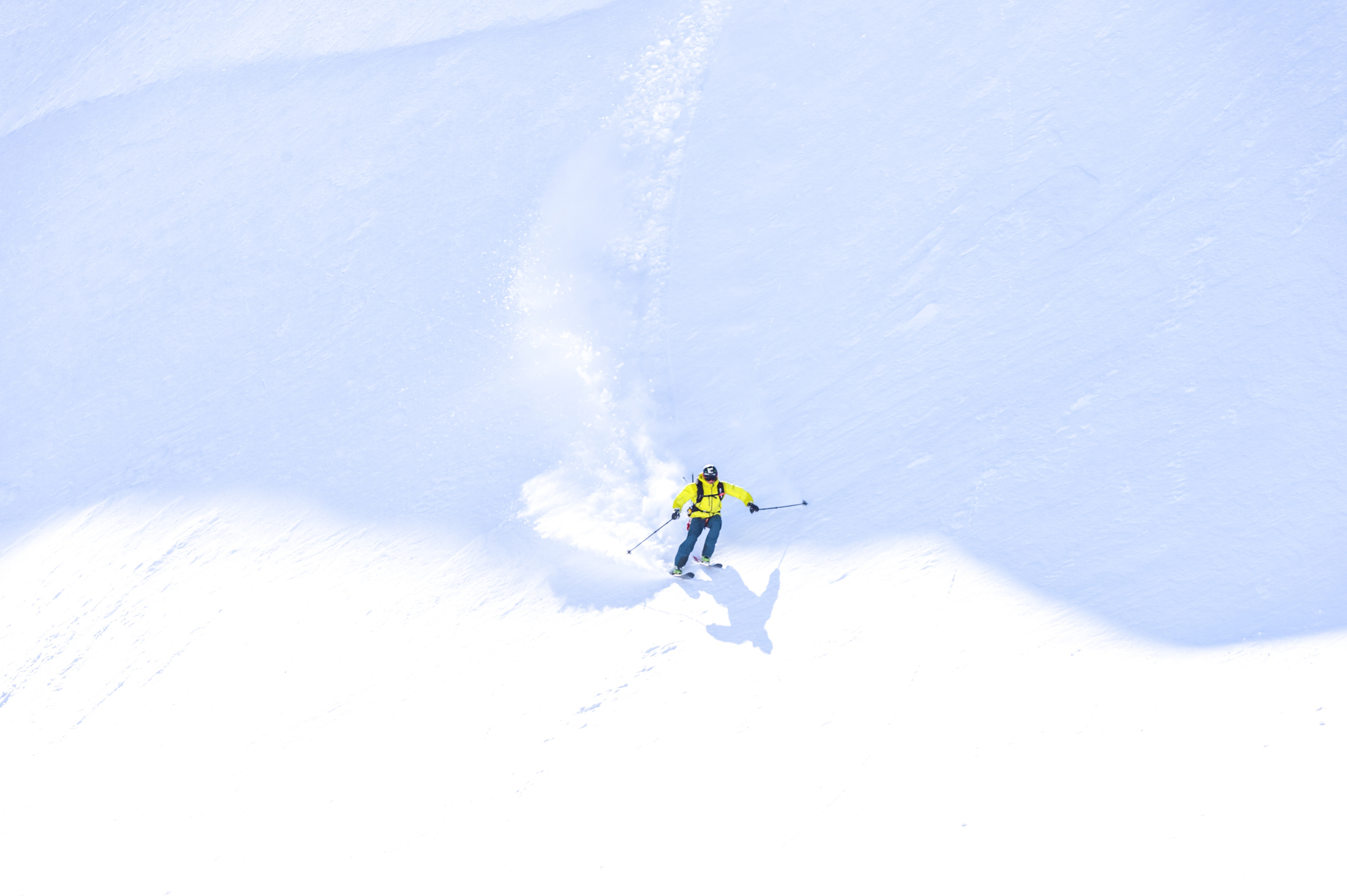Skier spraying snow as he turns