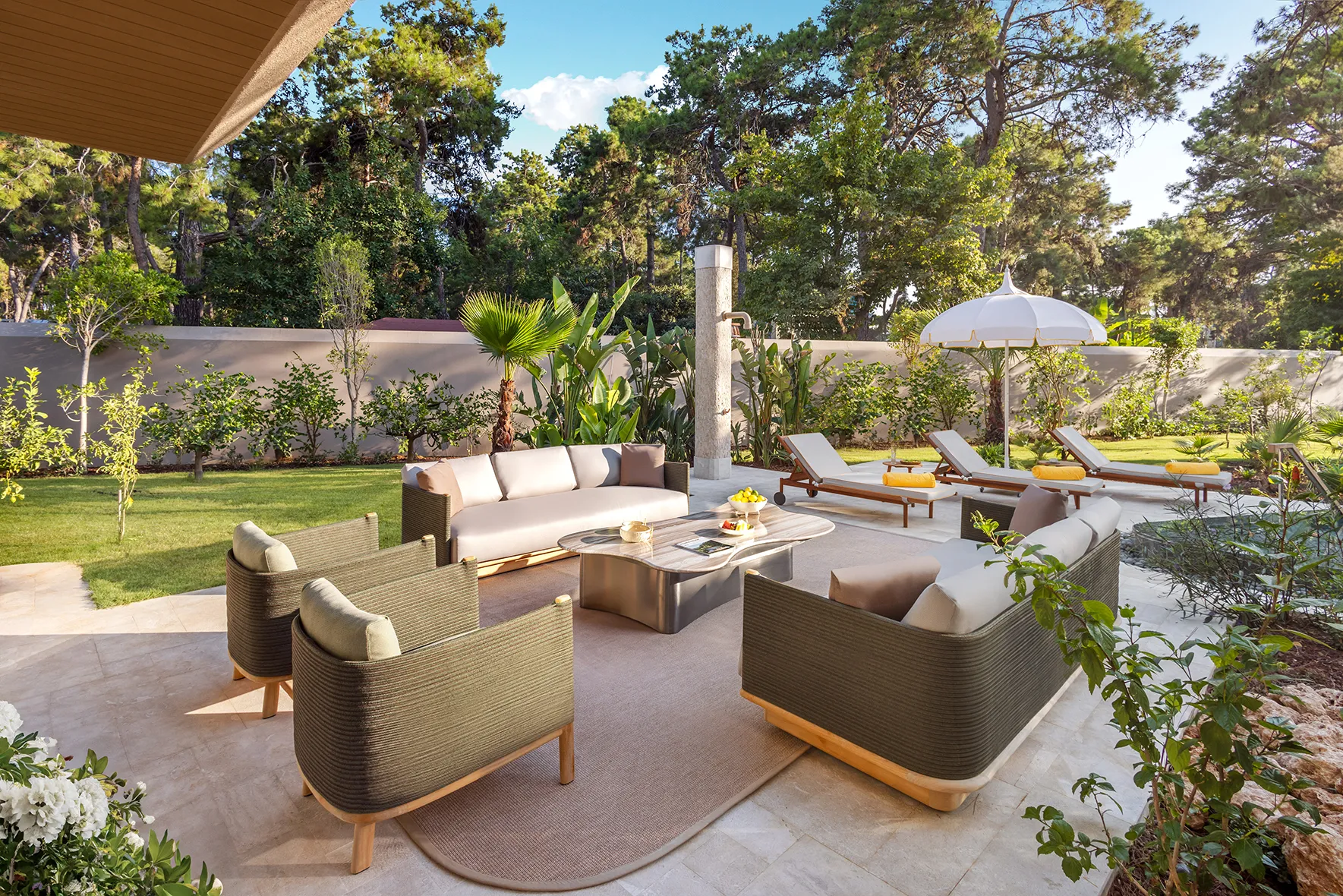 Europe, Turkey, Bijal, Corner Villa outdoor seatin with two sofas and two armchairs around a coffee table, and three shaded sunloungers in the background