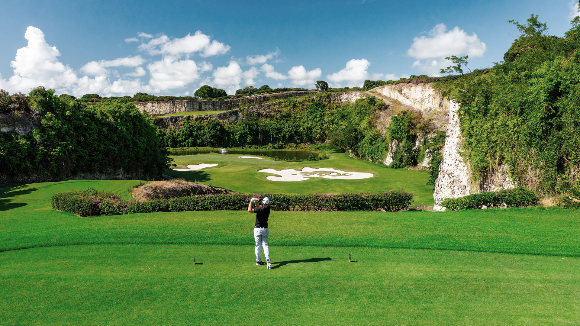 A golfer mid swing at Green Monkey Golf Course in Barbados