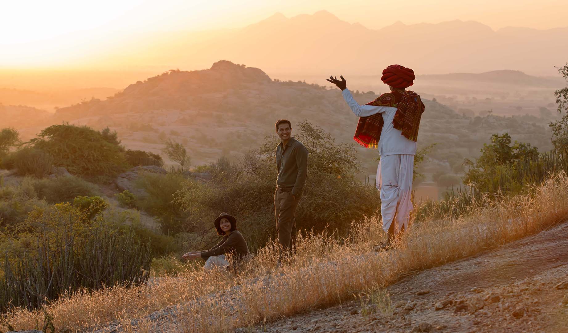 Asia, India, three people overlooking the landscape at sunset at Sujan Jawai 