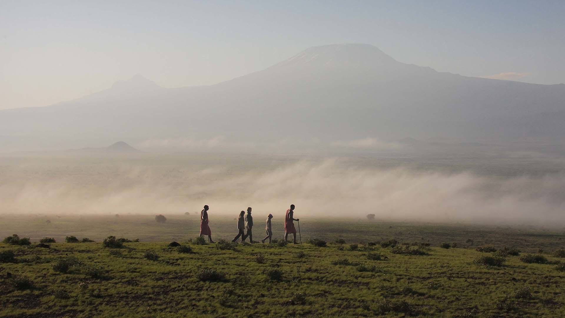 Group being lead by Maasai men through the landscape of Amboseli National Park