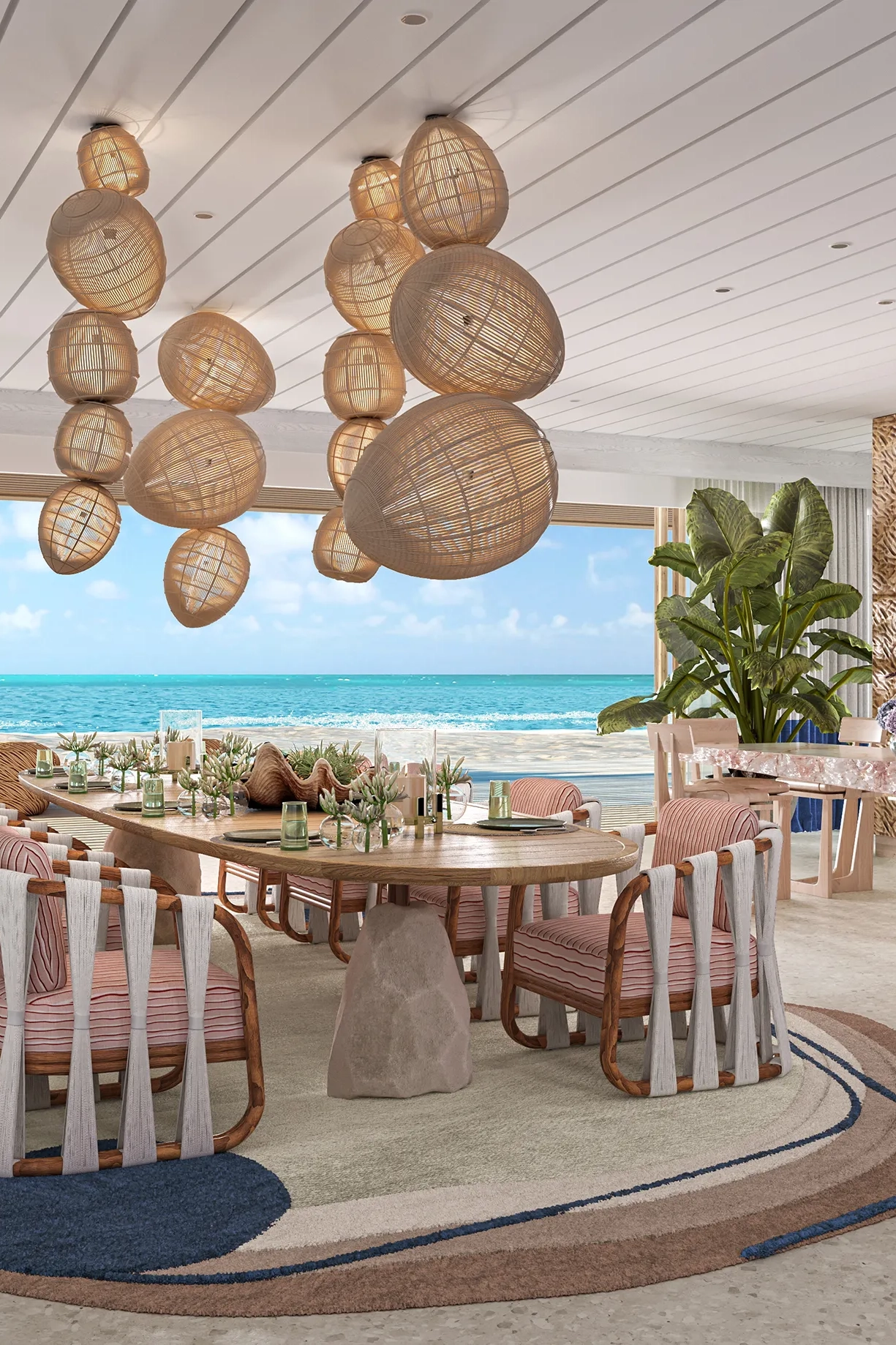 Luxury beachfront dining room in the Presidential Villa at .Here Resort in the Maldives with ocean views and elegant décor.