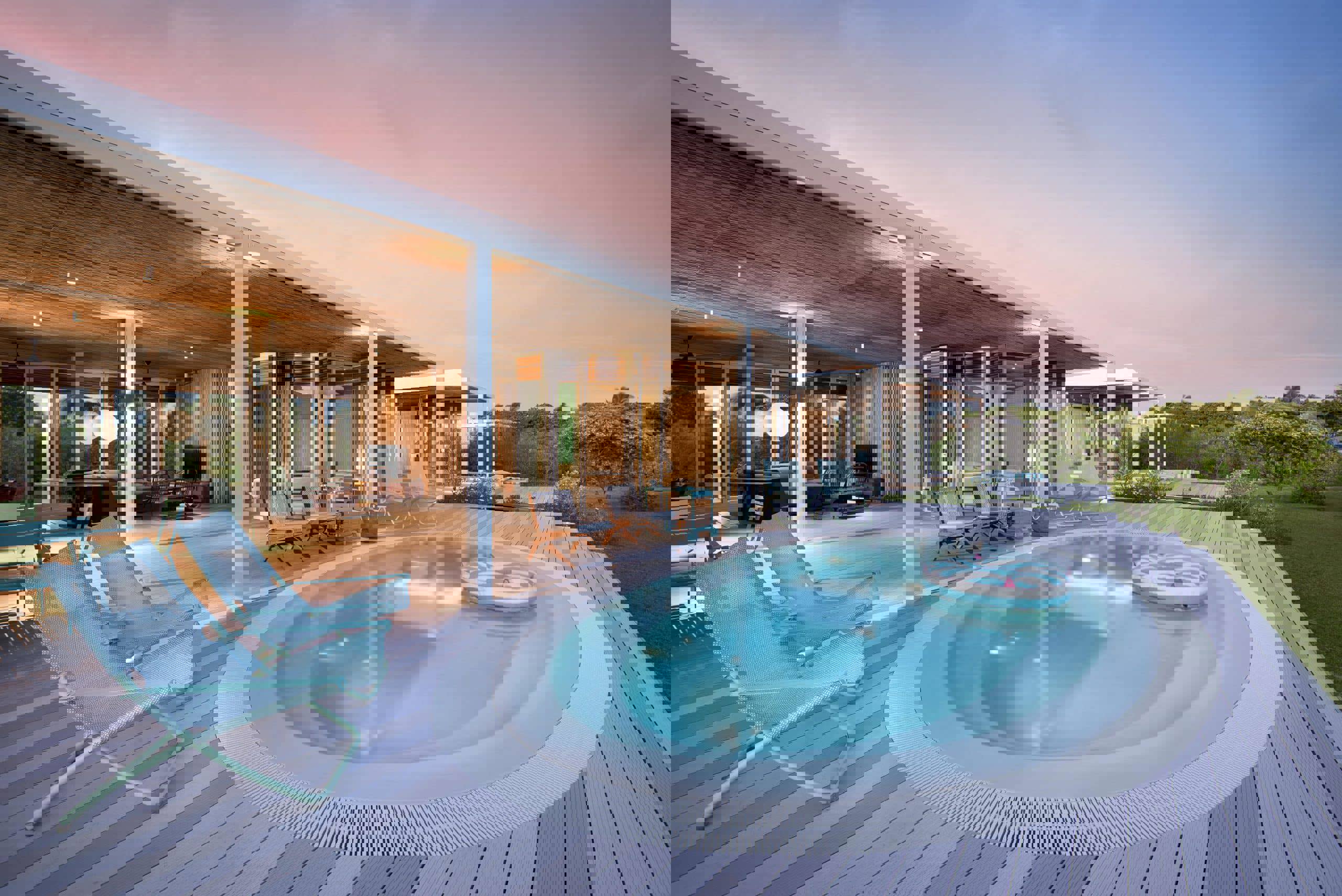 Miavana villa private pool on wooden terrace lit up for sunset