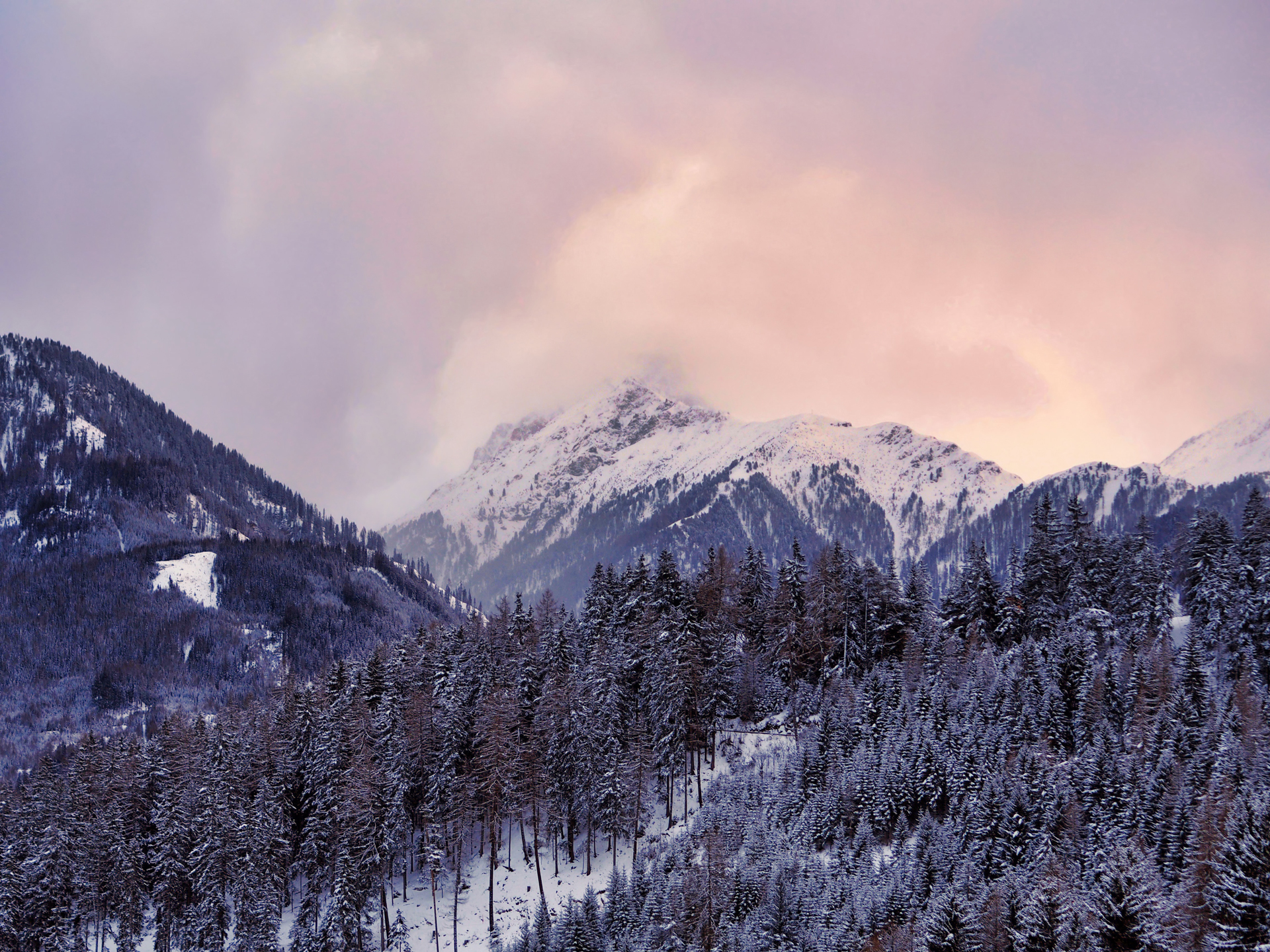 Aerial image of mountains with trees covered in snow