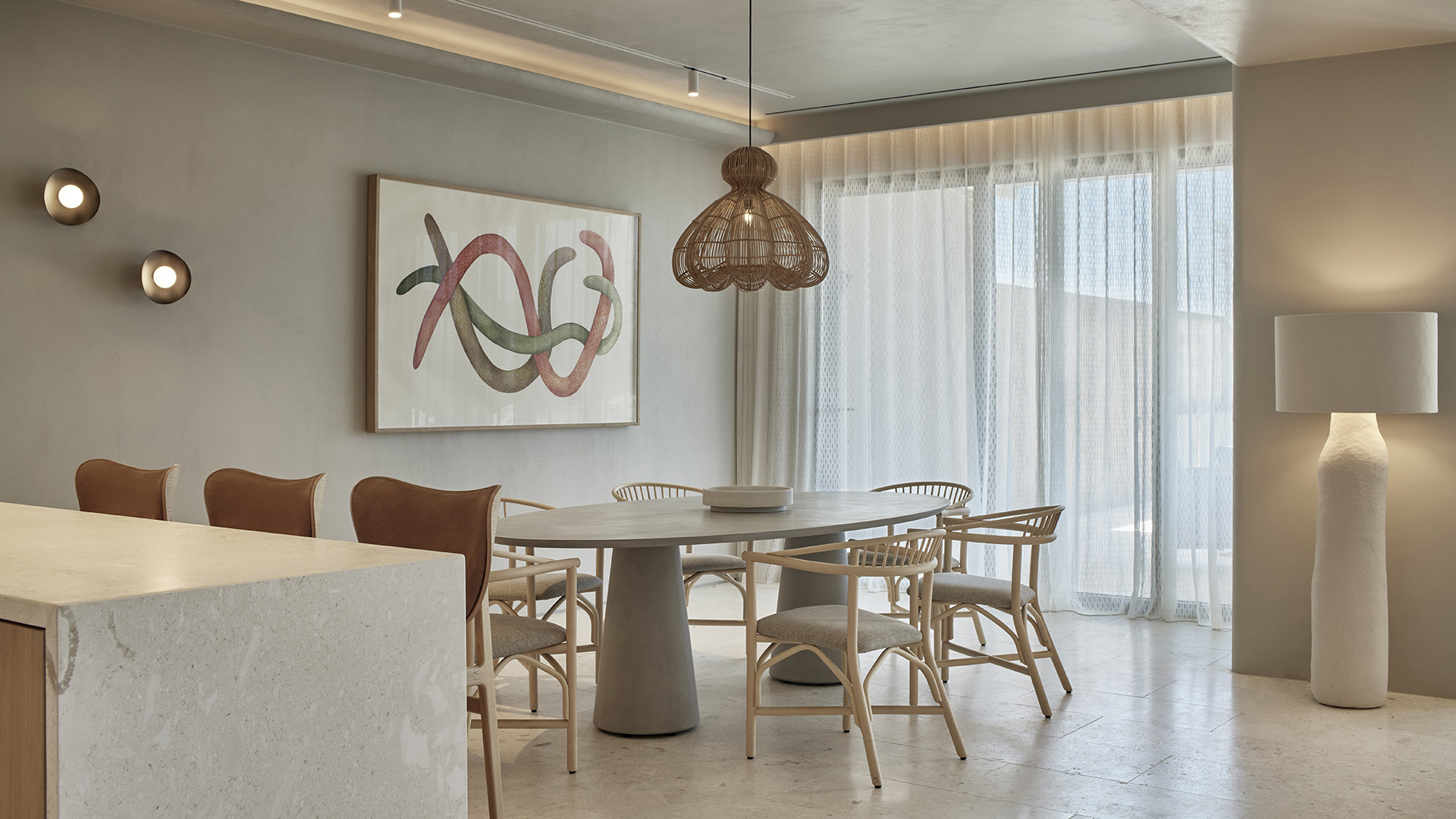 Villa dining room with stone table and snake artwork on wall at W Costa Navarino