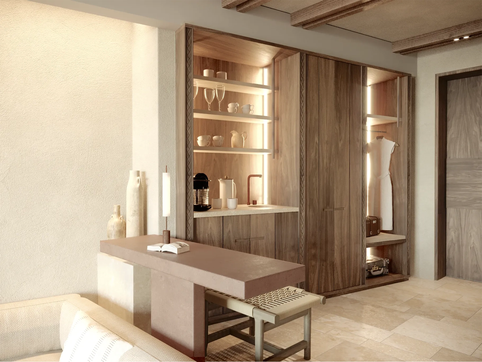 Suite interior with an open plan wardrobe, coffee station and small desk and chair behind a sofa 