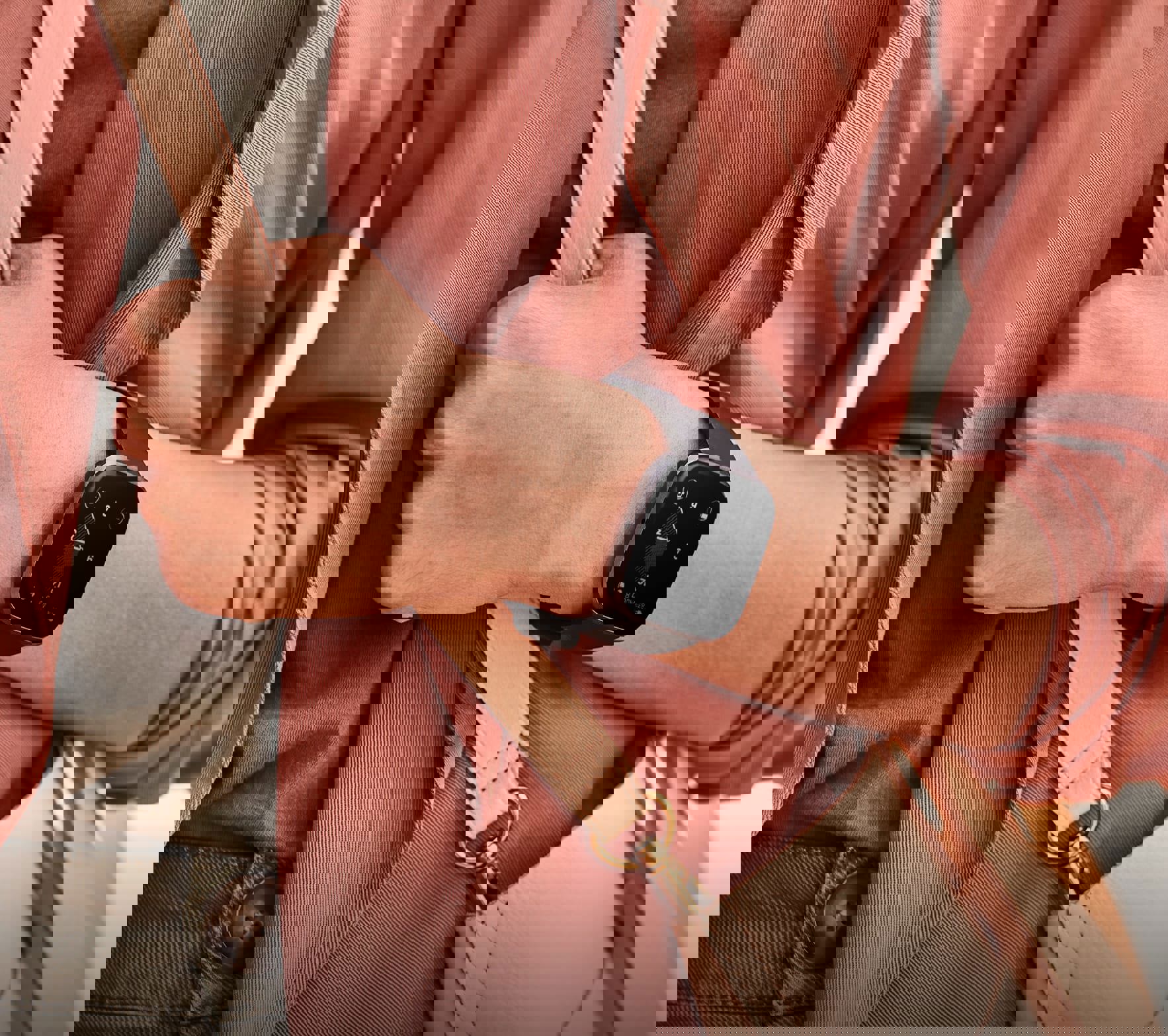 A close up shot of the Fitbit Versa 2 smartwatch in black on a woman's wrist