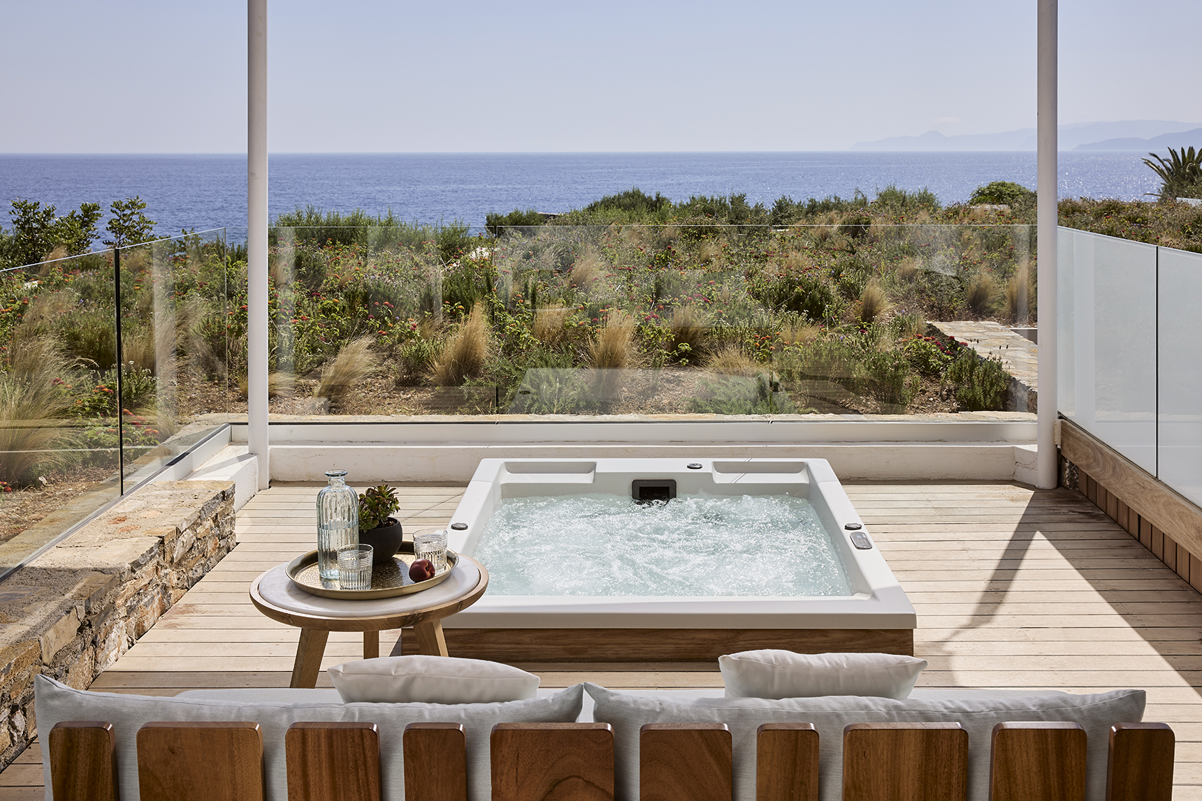 Europe, Greece, Crete, St. Nicolas Bay Resort Hotel & Villas, Classic Suite outdoor hot tub with sea view