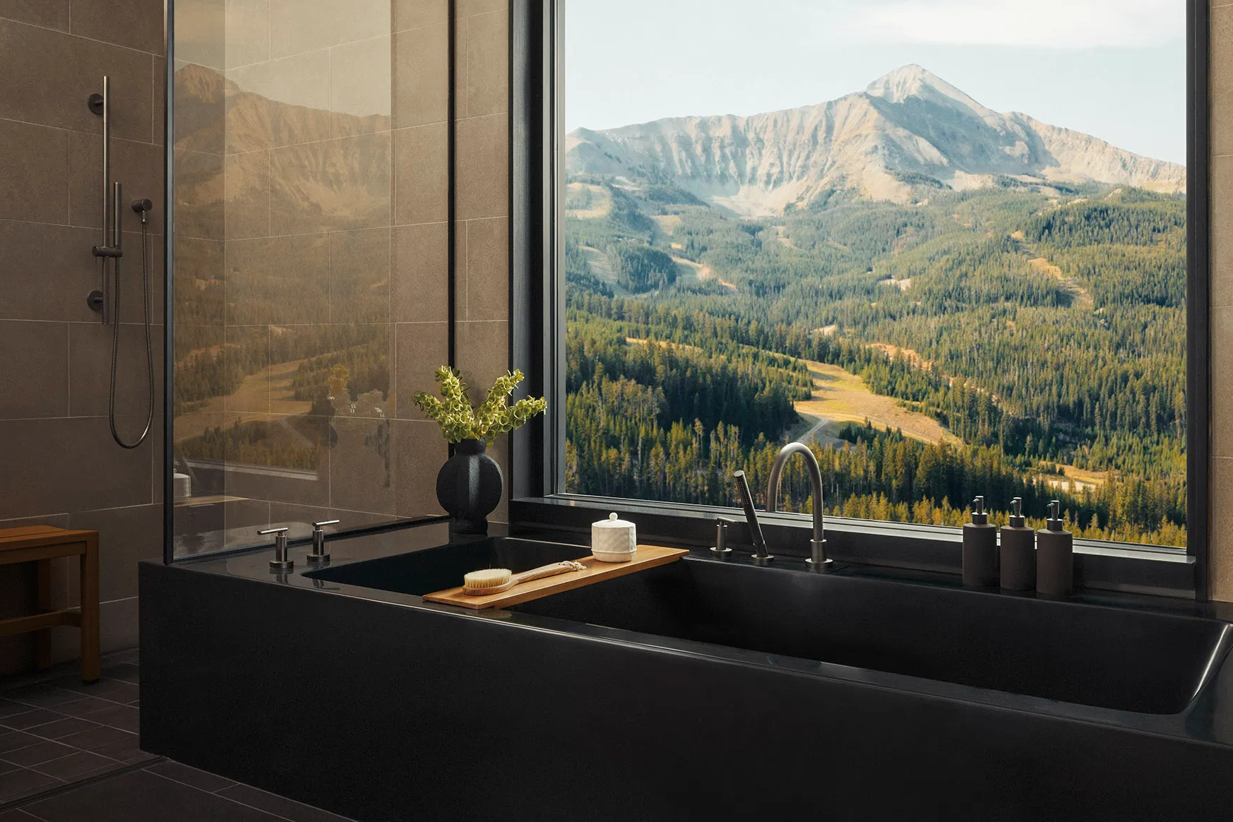 Bath with a window view of Mountains and fir tree forests at One&Only Moonlight Basin, Montana, USA