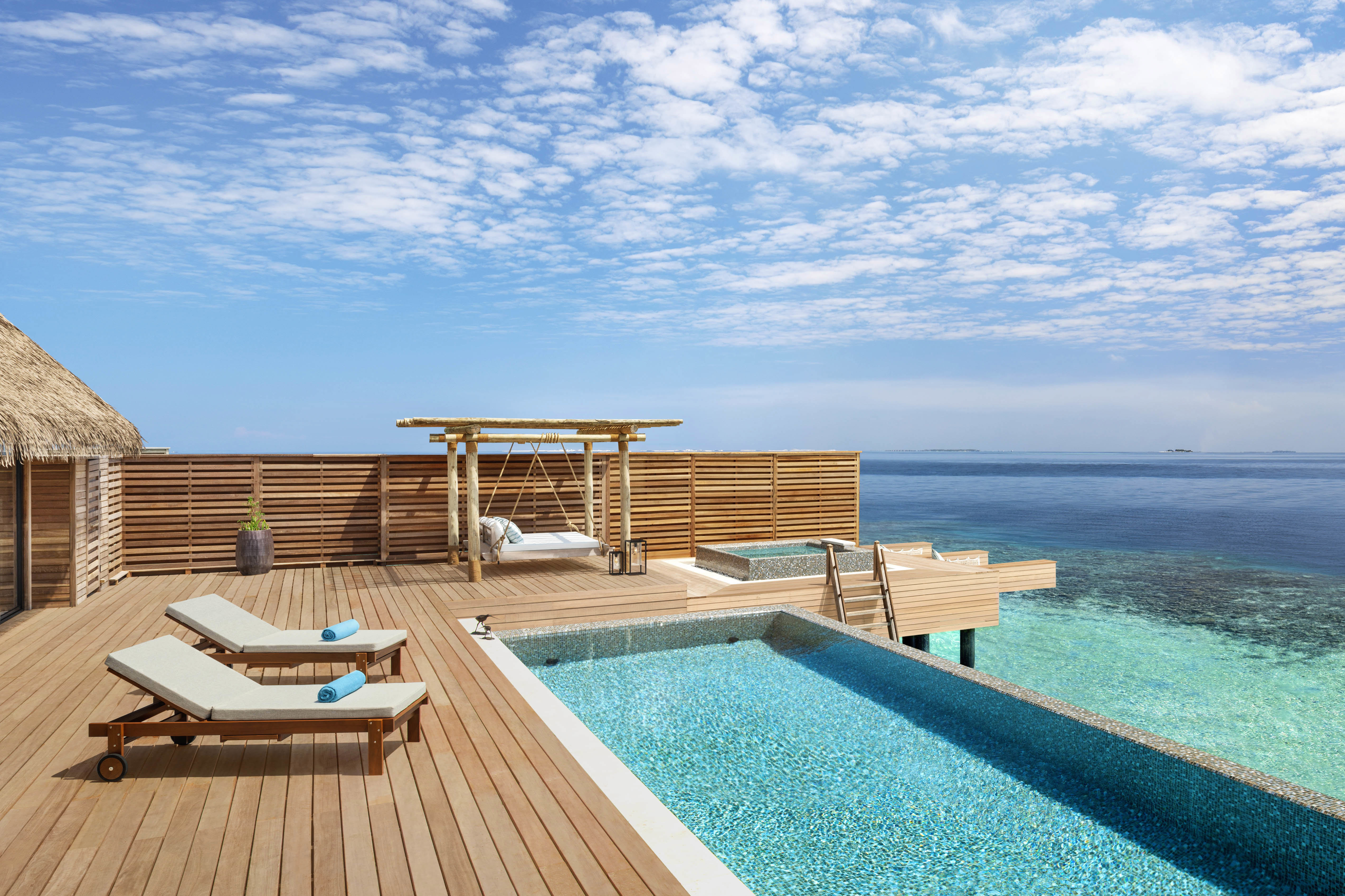 Wooden terrace and hammock on the terrace of Three Bedroom Overwater Villa with private pool overlooking the lagoon