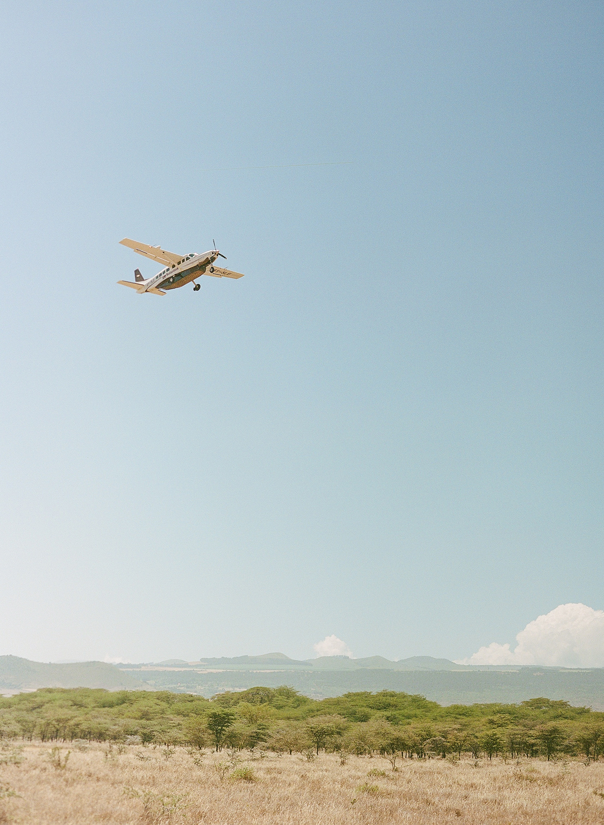 Africa, Kenya, Elewana Kifaru House, small propeller plane flyign over the bush