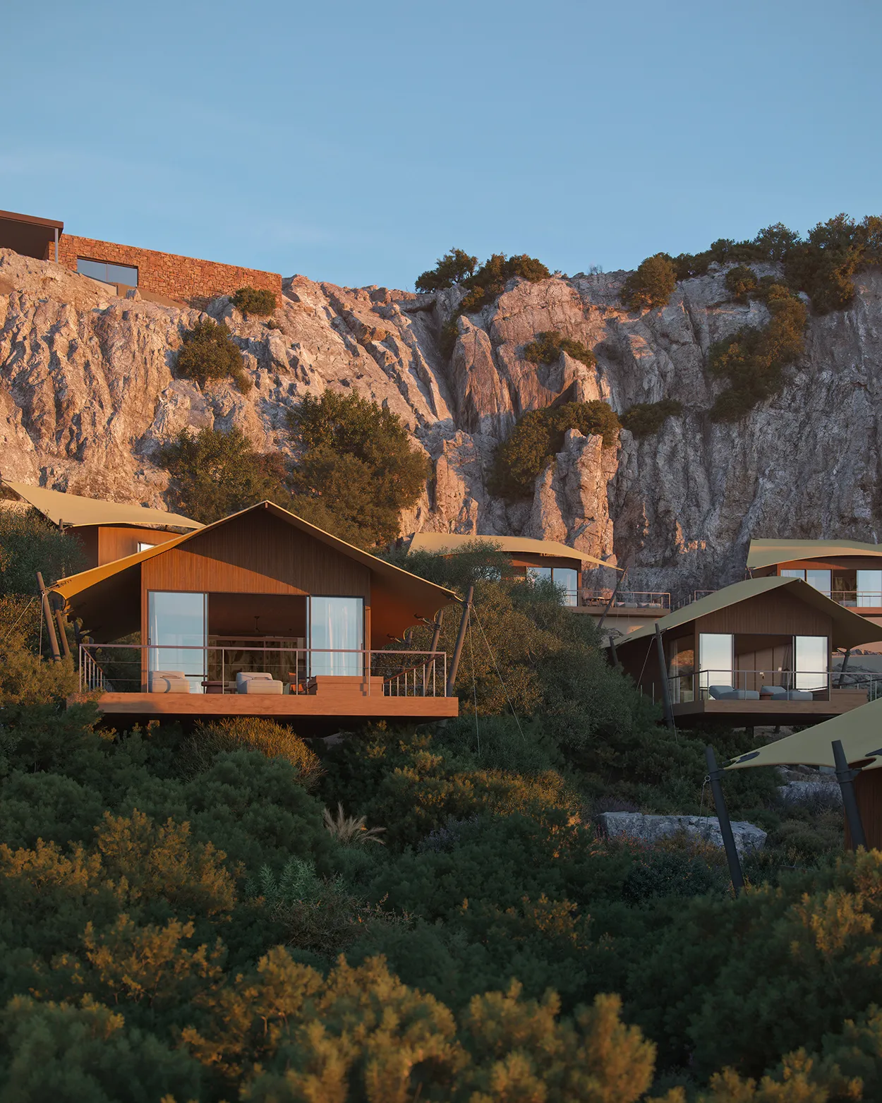 Luxury tented suites set above greenery and against a rock face