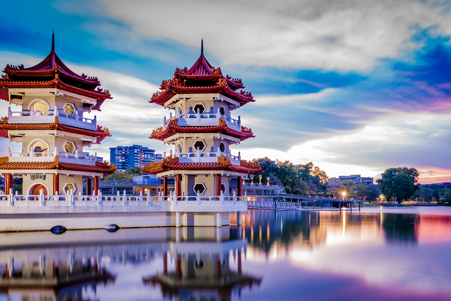 Red and white temples next to a body of water