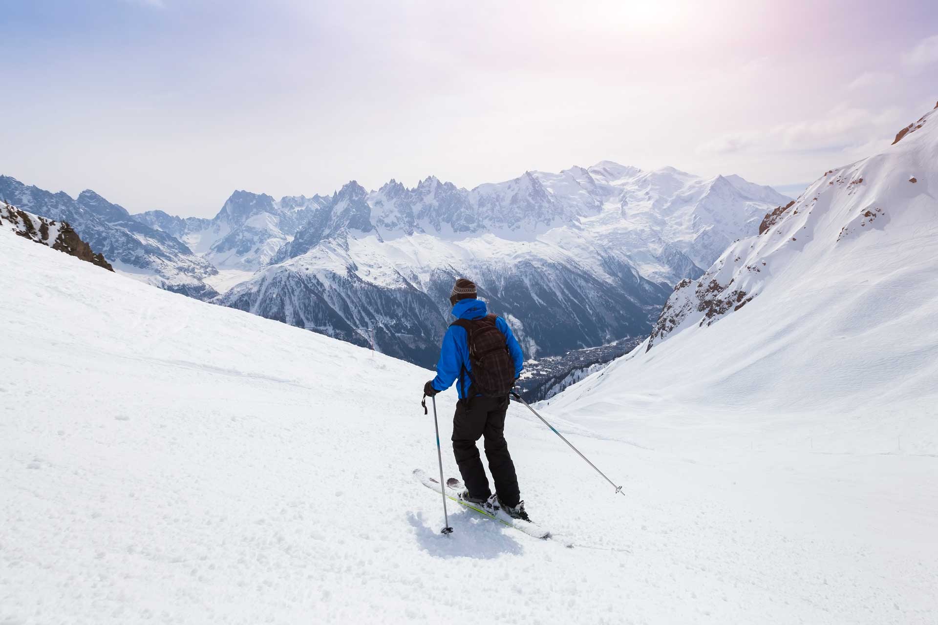 Skier skiing on a snowy slope in Alps mountains